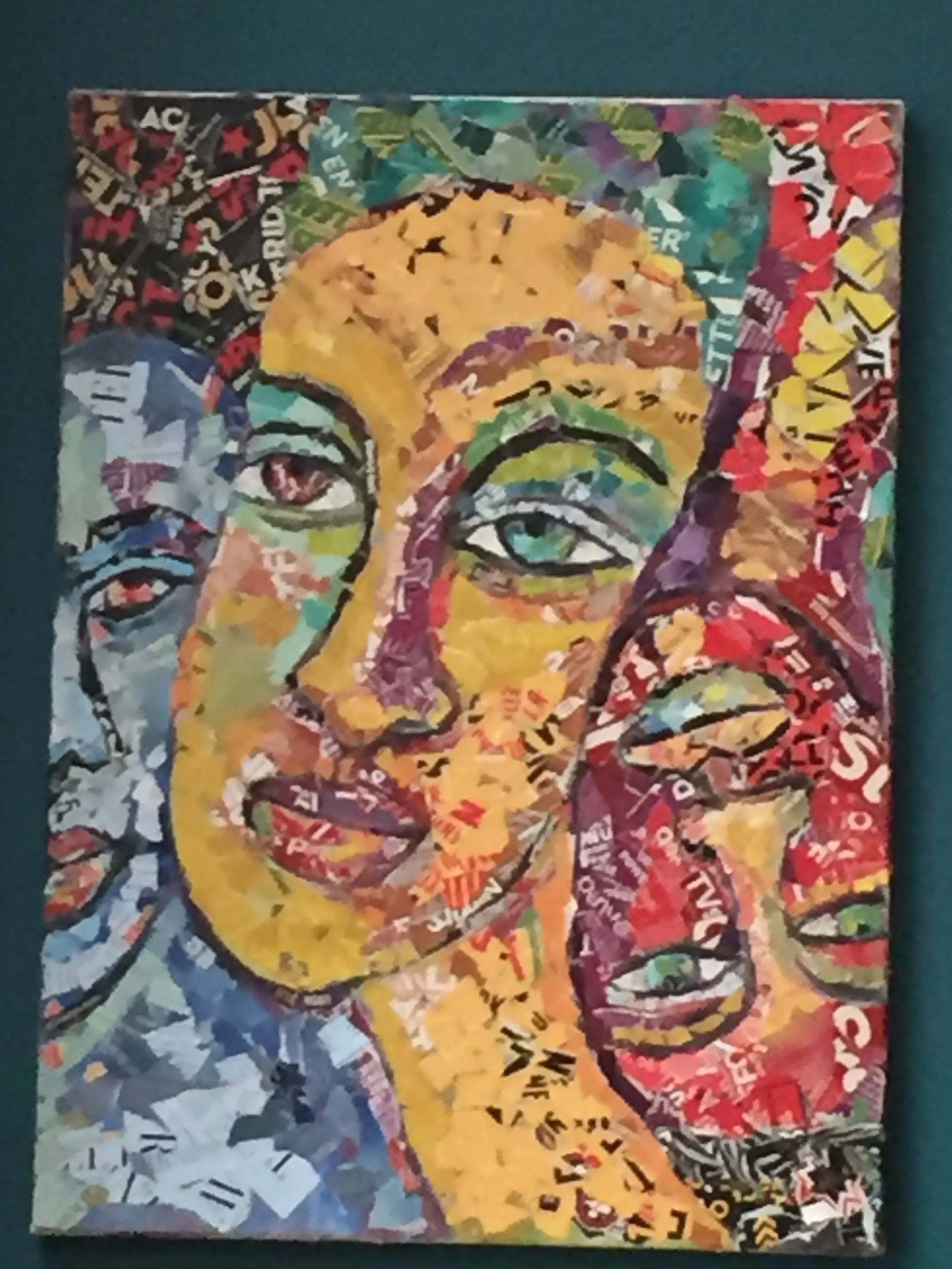 Colorful collage of faces created with layered cut-out text and images, forming an abstract portrait.