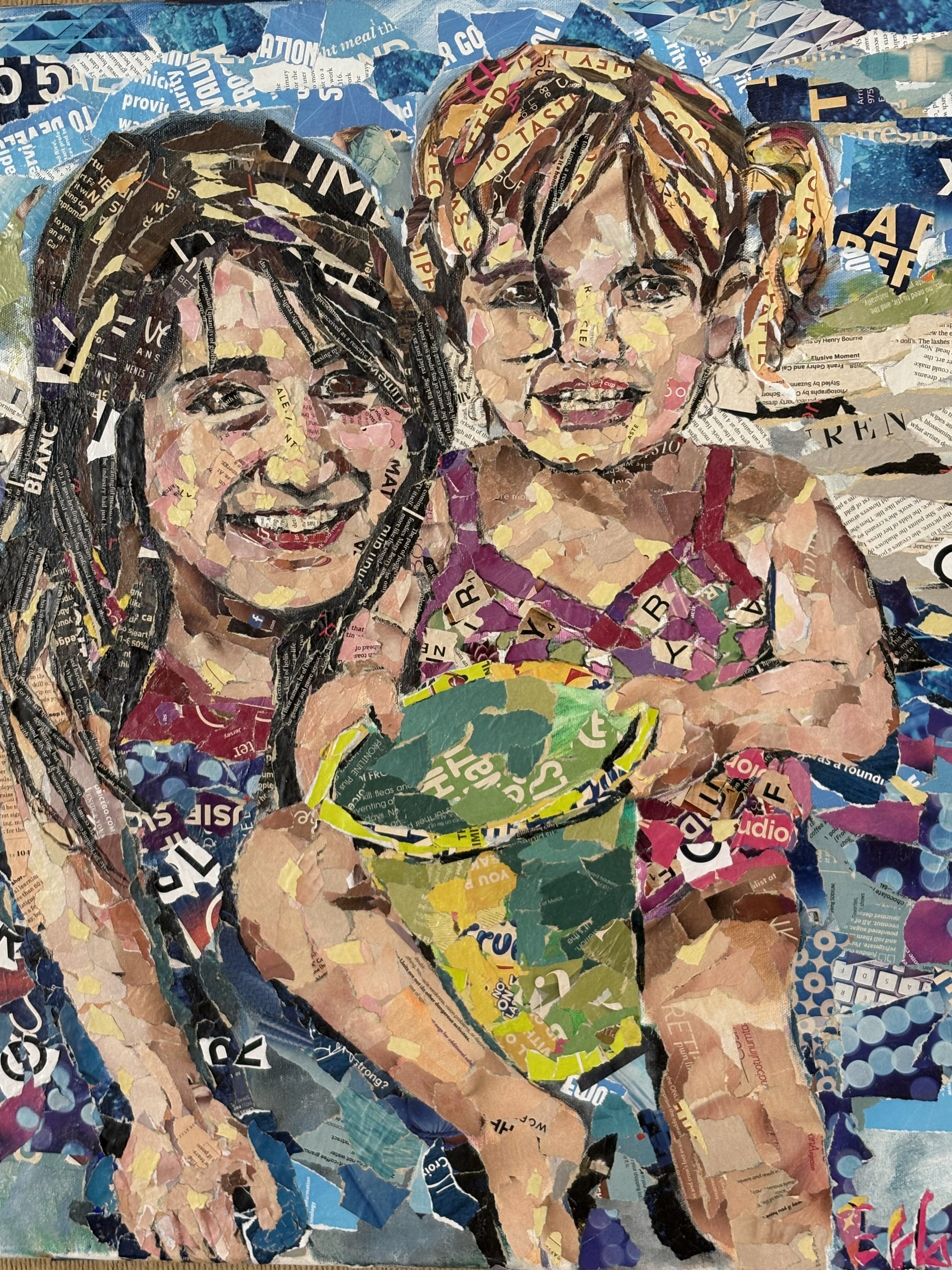 A collage portrait of two young girls made from torn magazine and paper pieces. One girl has dark hair and a bright smile, the other has light hair with pigtails and is holding a ball, looking at the camera.