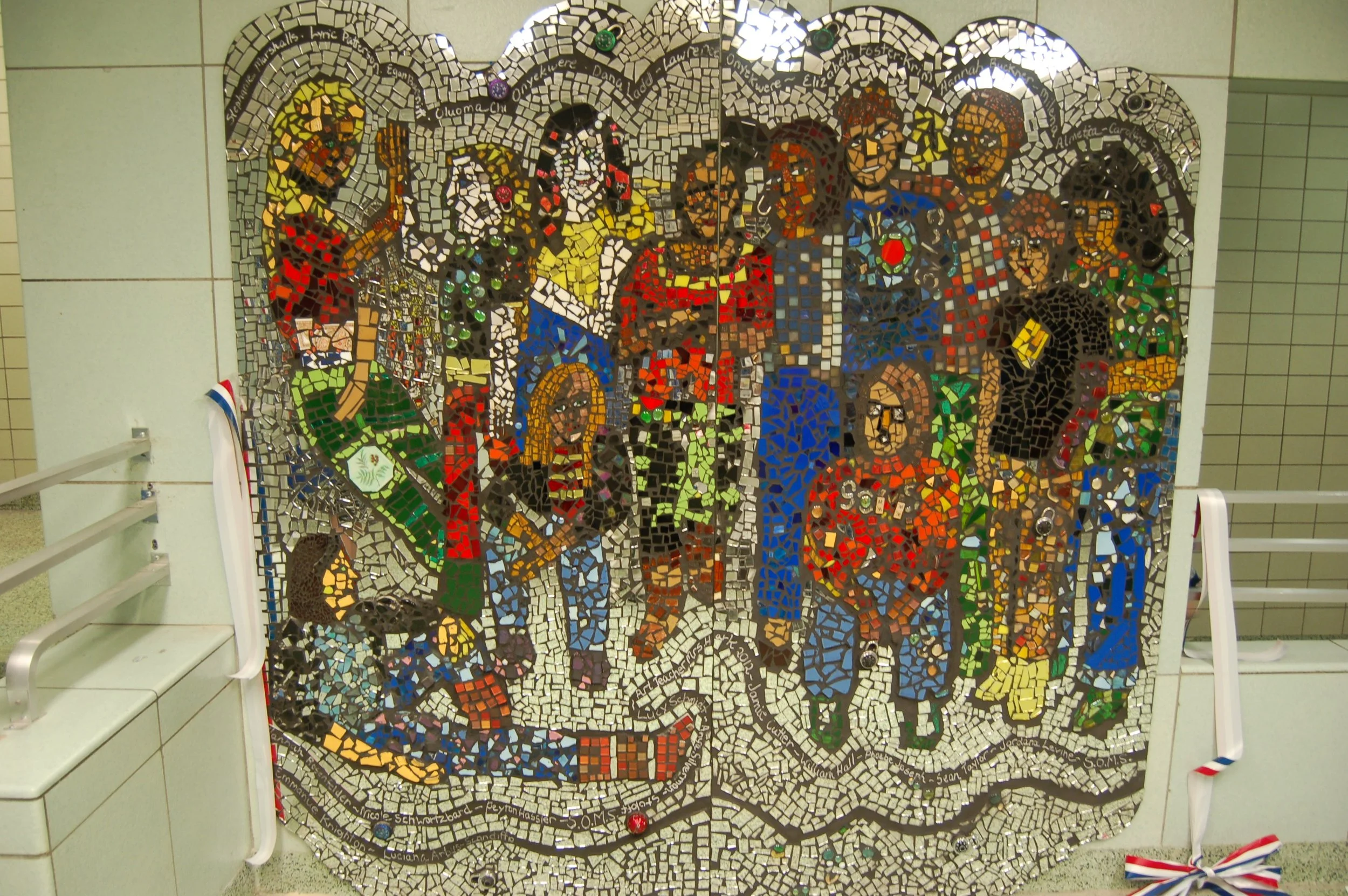 Colorful mosaic mural depicting diverse children and a teacher in a classroom setting.