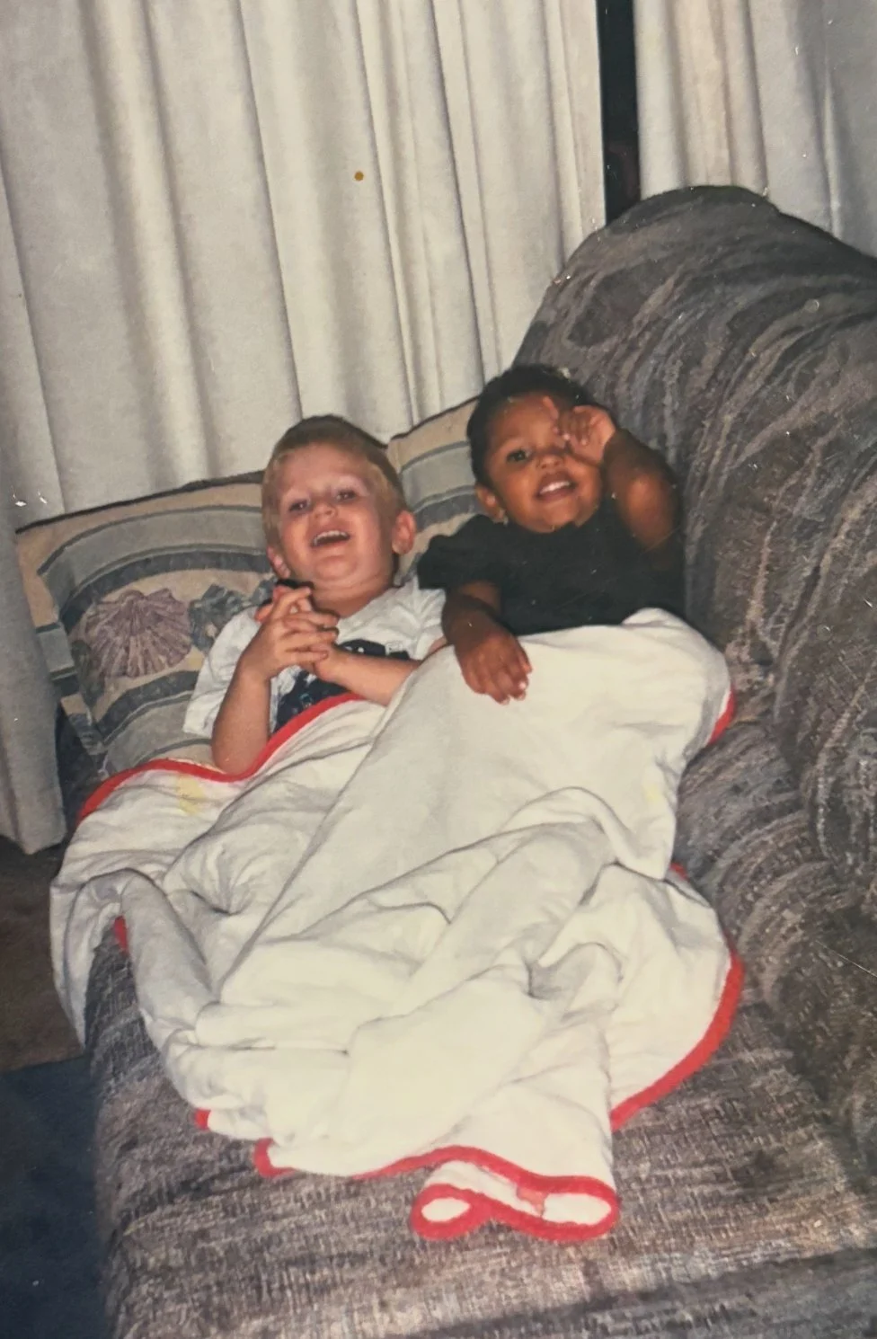 Collin Fearns lying on a couch with a childhood friend