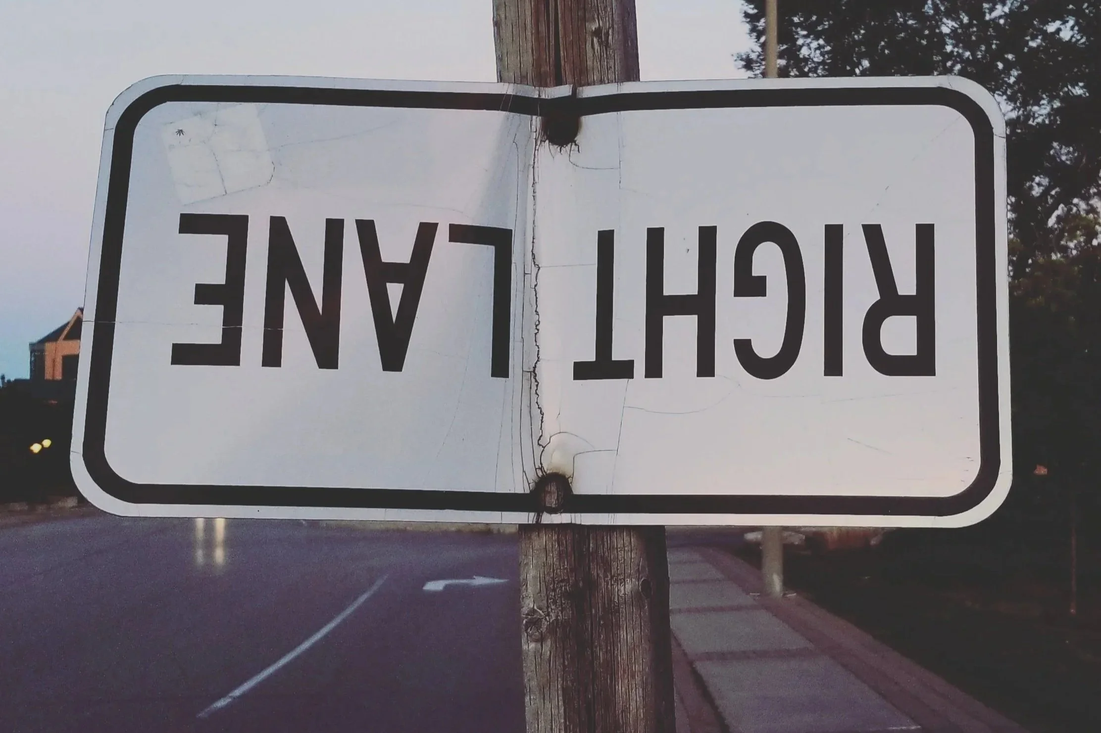 A street sign flipped upside down