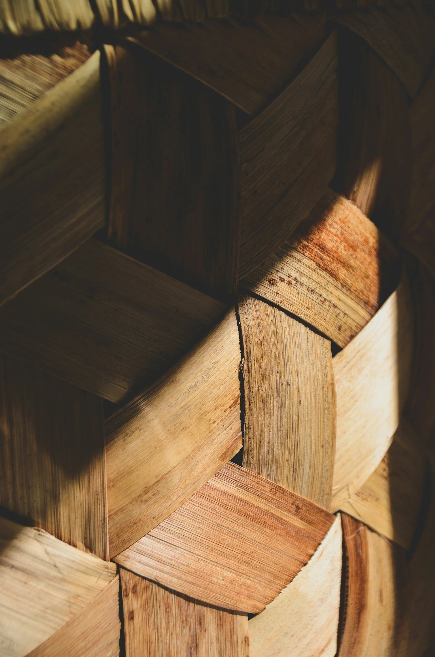 Close-up of woven wooden tiles with varying shades of brown and beige.