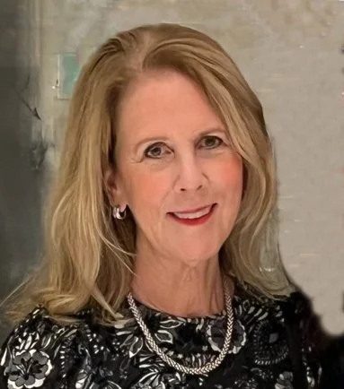 A smiling woman with blonde hair