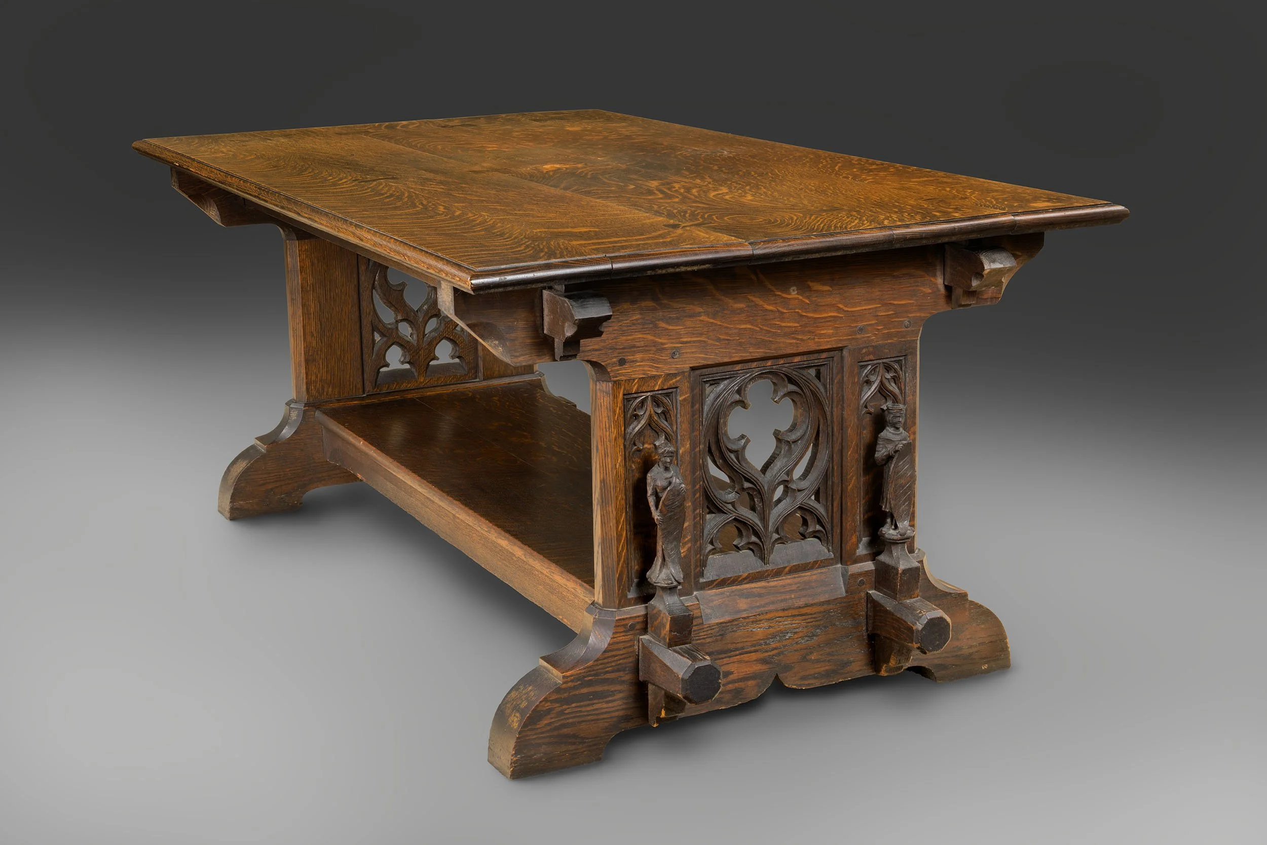 A large wooden table with ornate leg detail