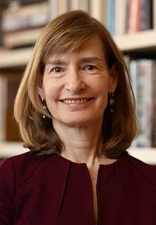 A smiling woman in a maroon top