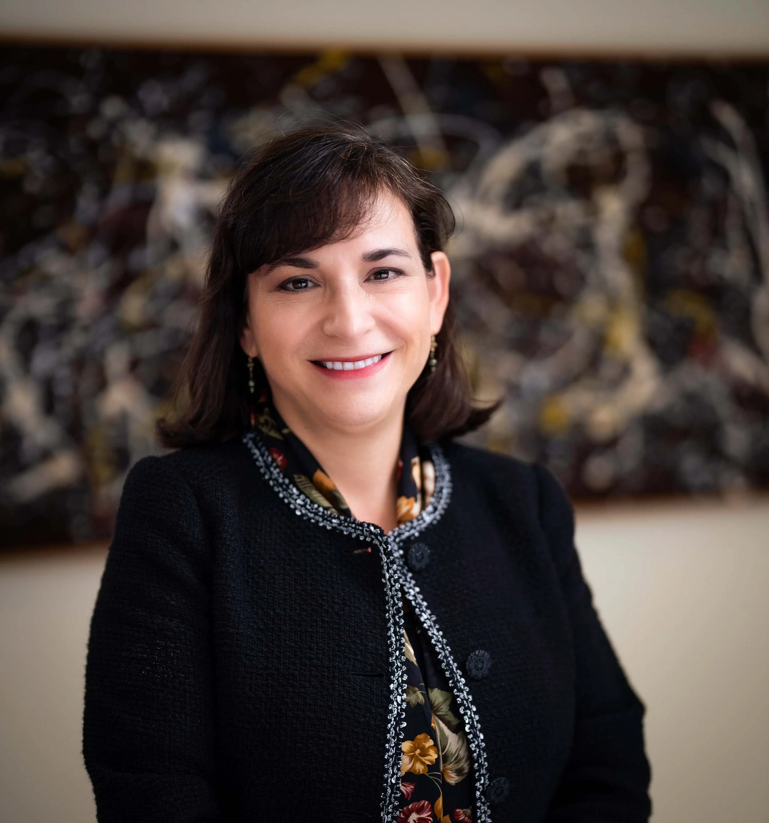A smiling woman in a dark blazer