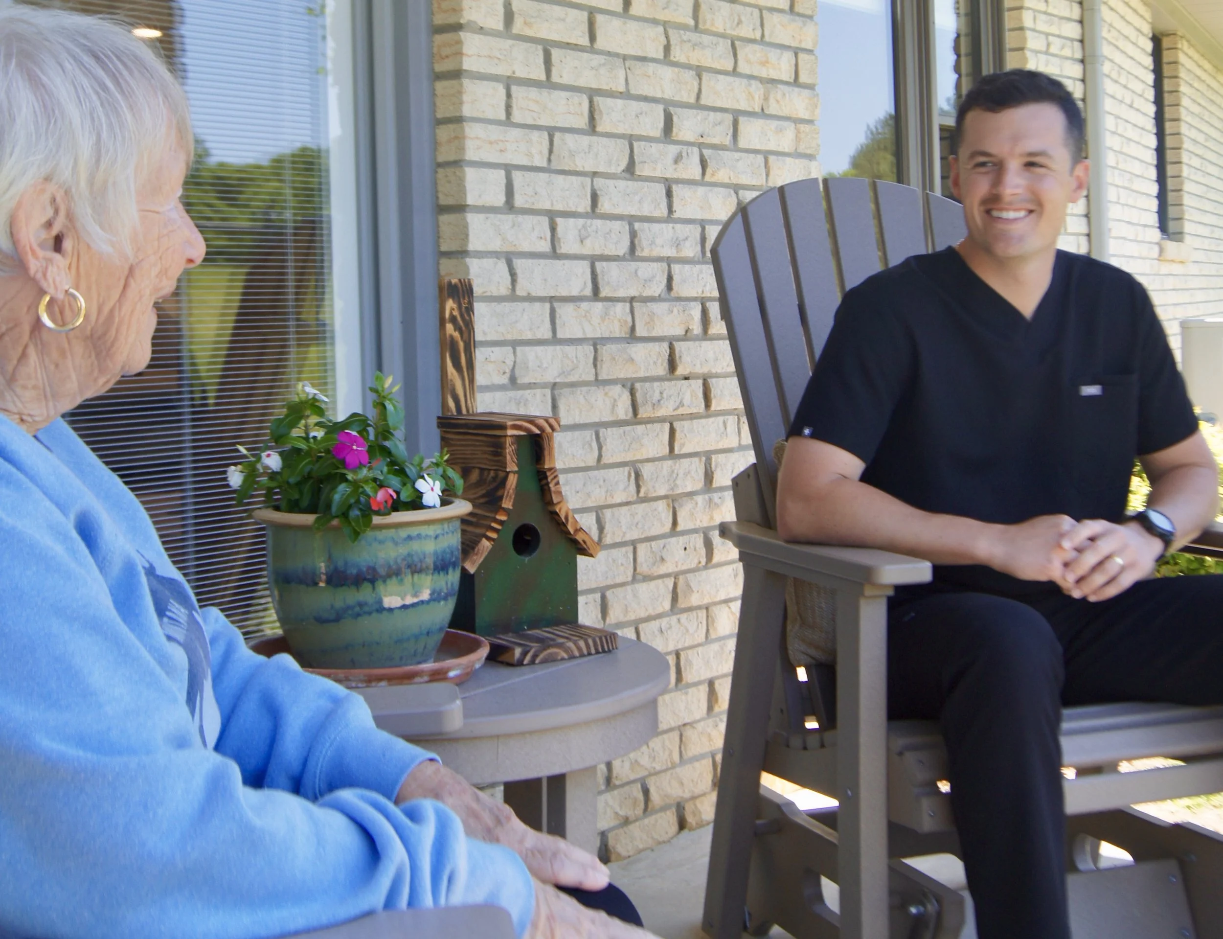 Compass Concierge Nursing founder Gus Osgood RN visiting with an elderly client on her porch during an in-home nursing check-in in Nashville