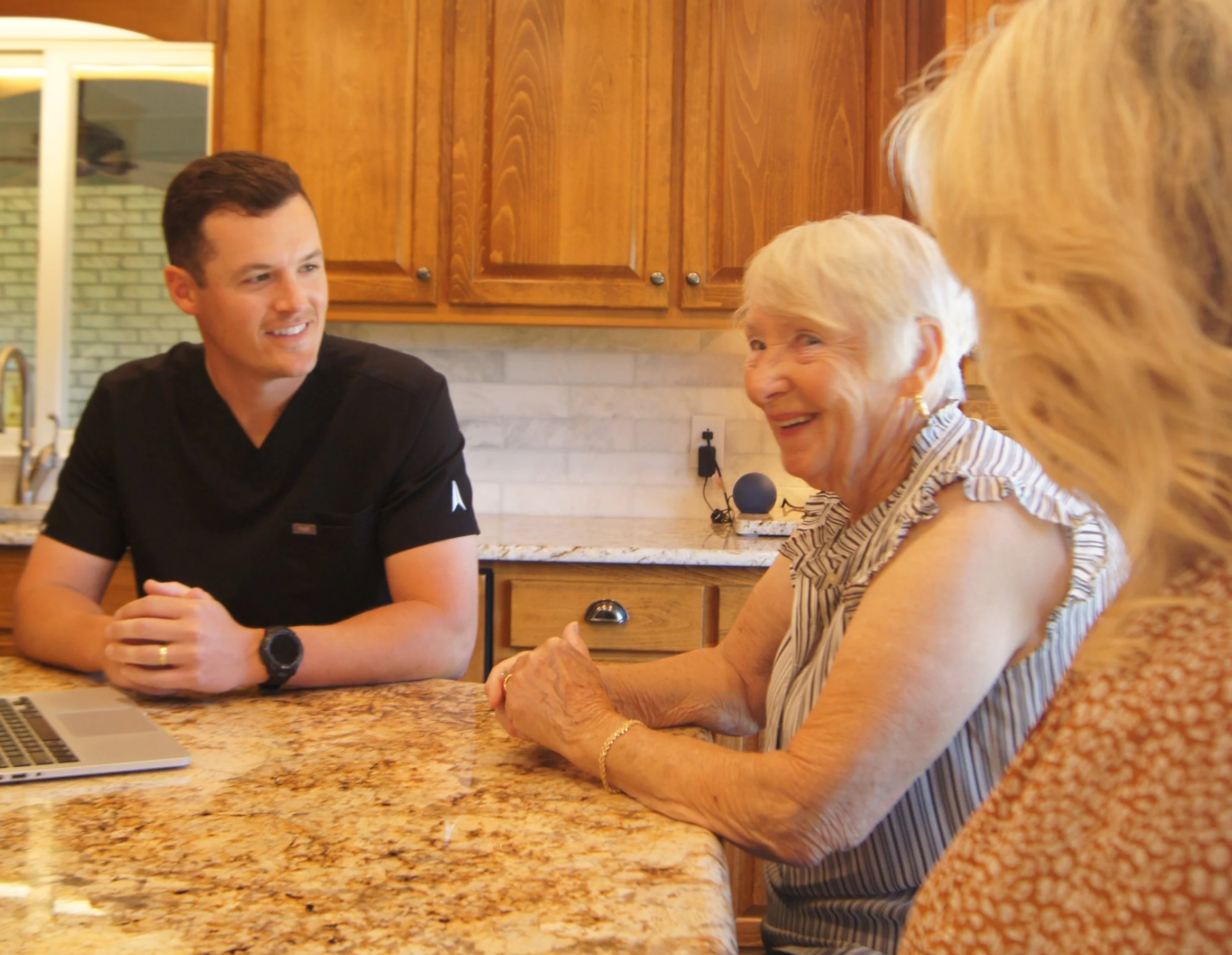 Gus Osgood RN consulting with an elderly client and her daughter during a home visit in Nashville Tennessee