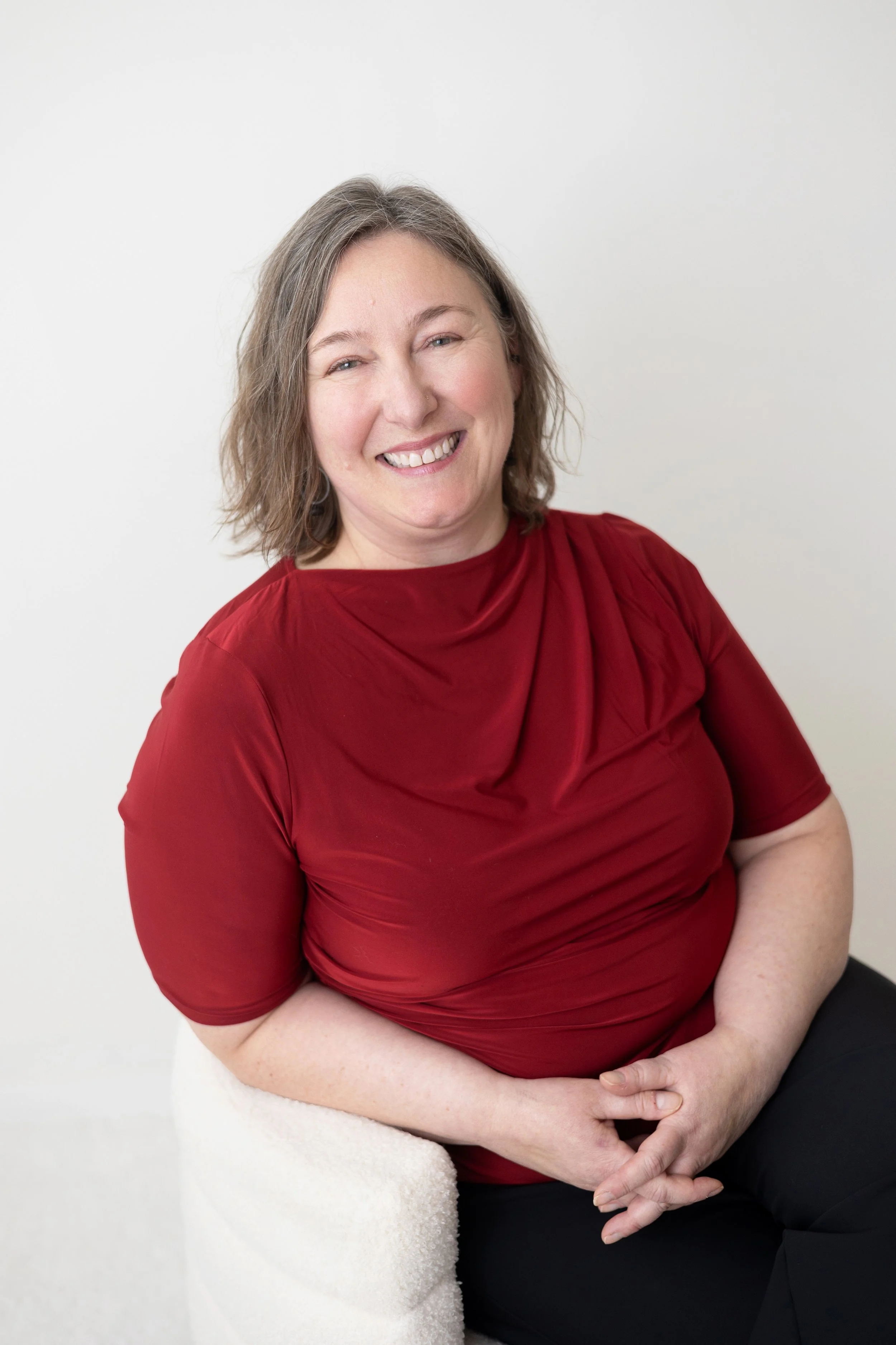 Picture of Chris Chiros looking photogenic for a change, wearing a red shirt.