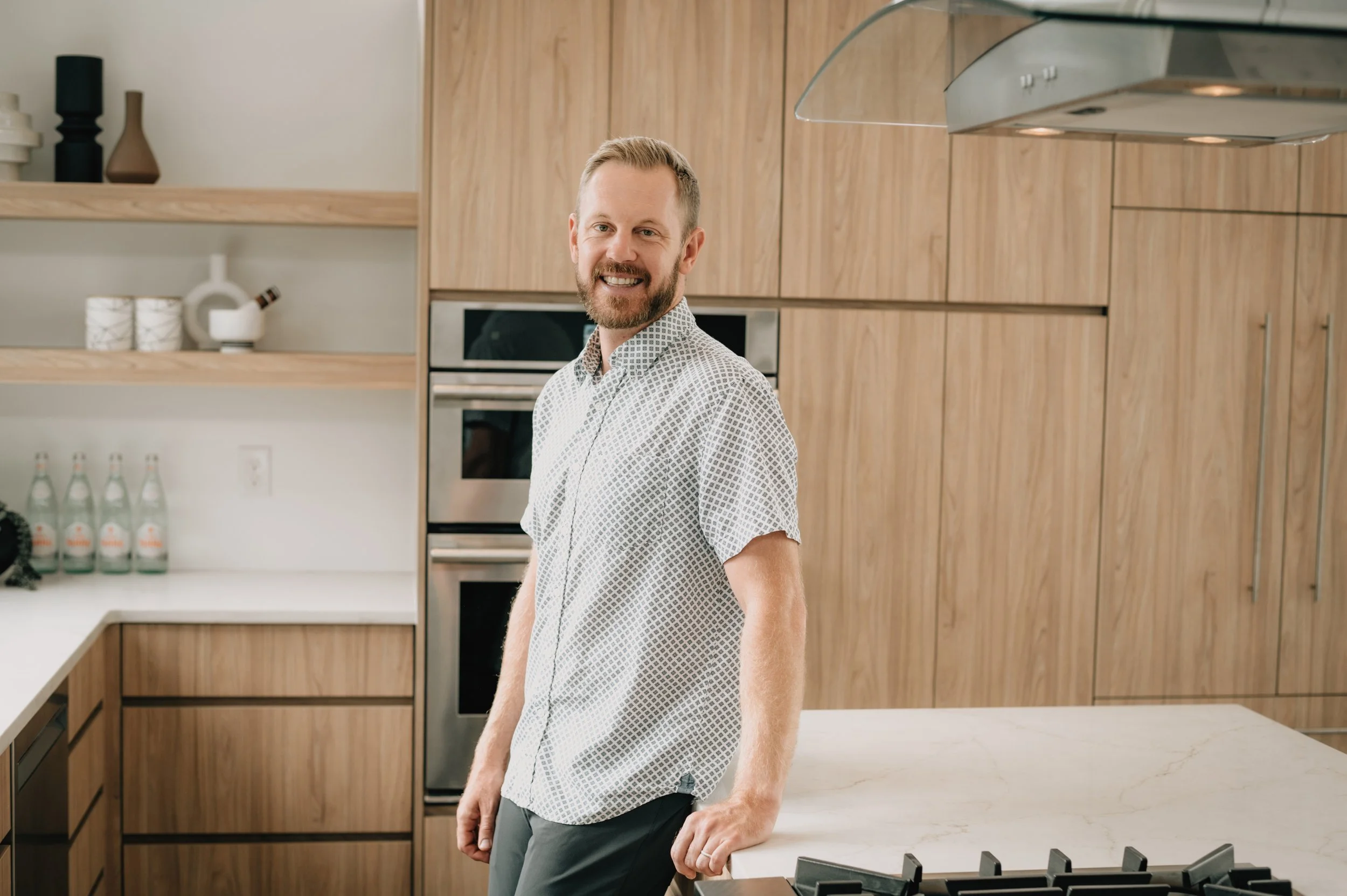 Denver real estate agent advising home buyers in a modern kitchen setting