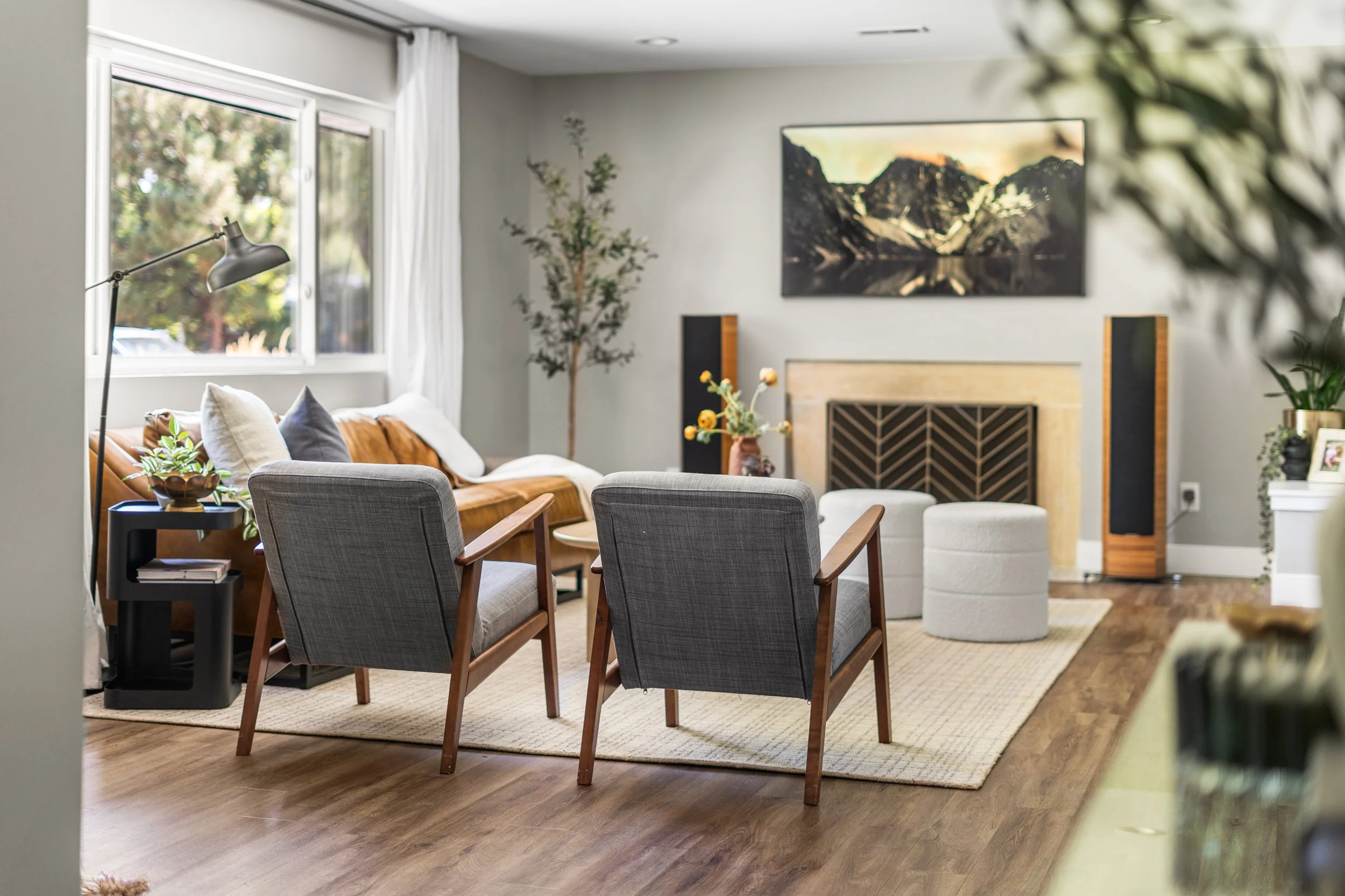 Living room interior of a Denver home featuring hardwood floors, modern seating, and natural light.