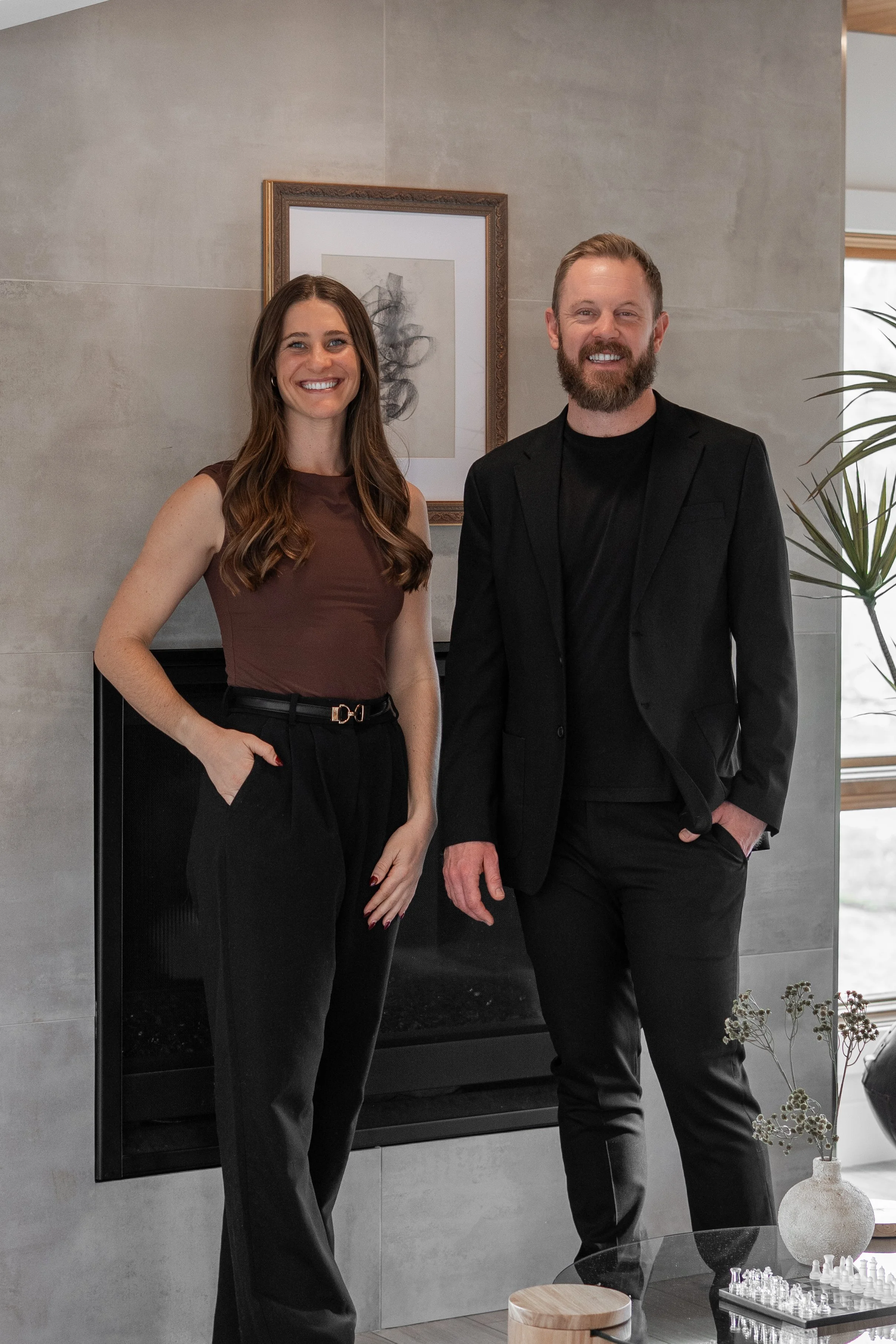 The Eminence Group Denver real estate agents standing in a modern home during a client consultation.