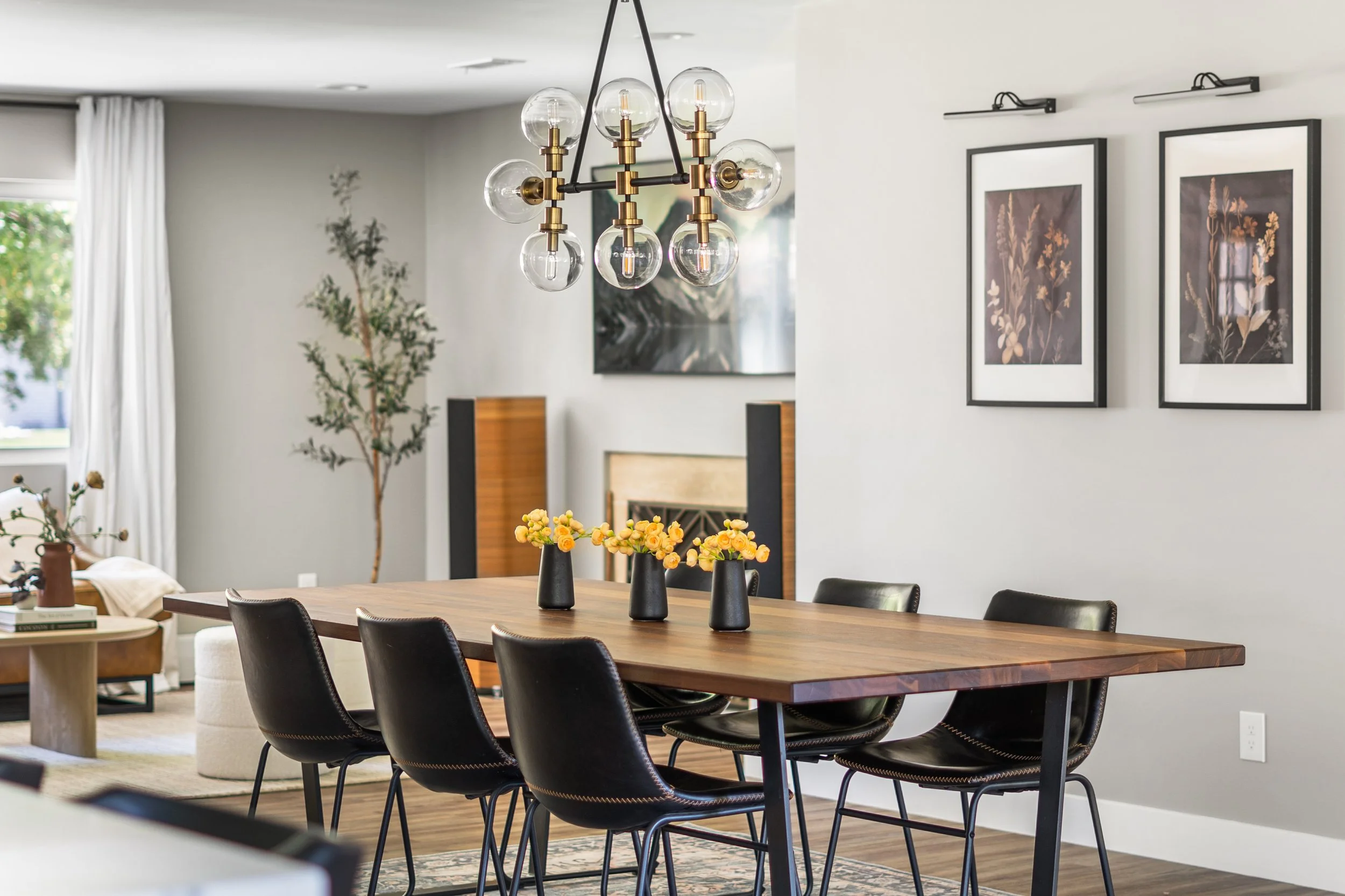 Modern Denver dining room with wood table, black chairs, and contemporary lighting