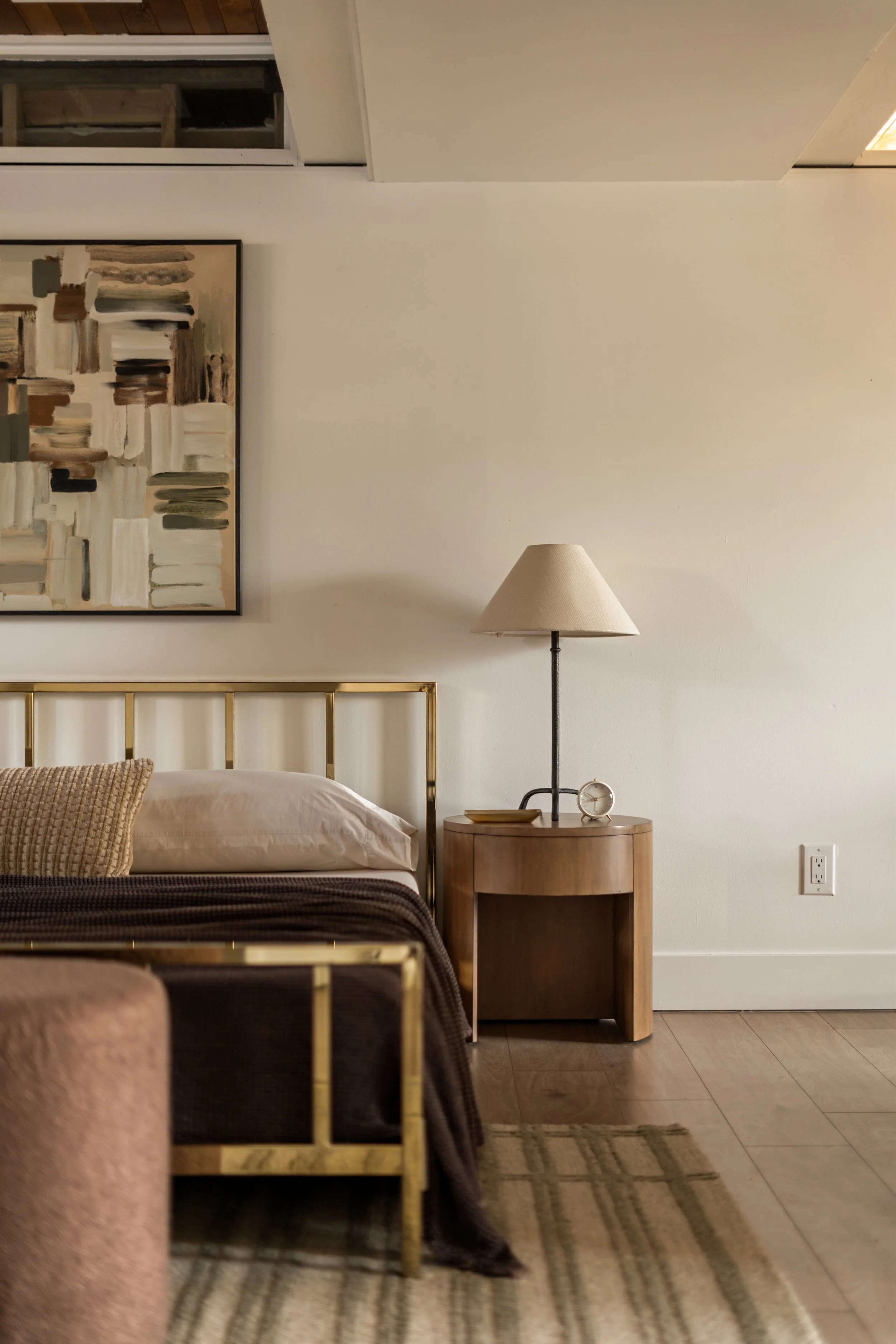 Interior bedroom of a Denver home featuring hardwood floors, neutral walls, and modern furnishings.