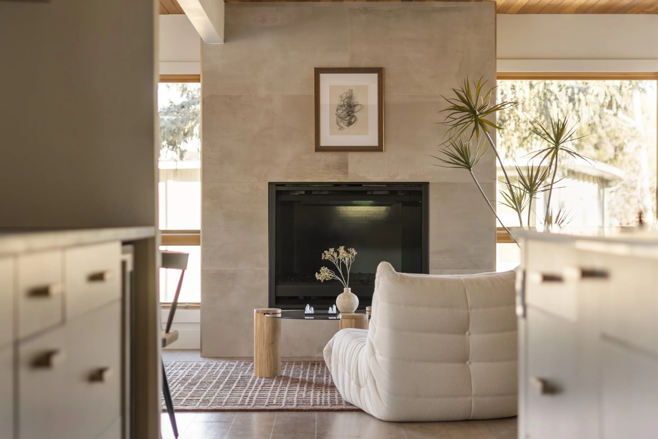 Modern Denver living room with fireplace, natural light, and wood accents