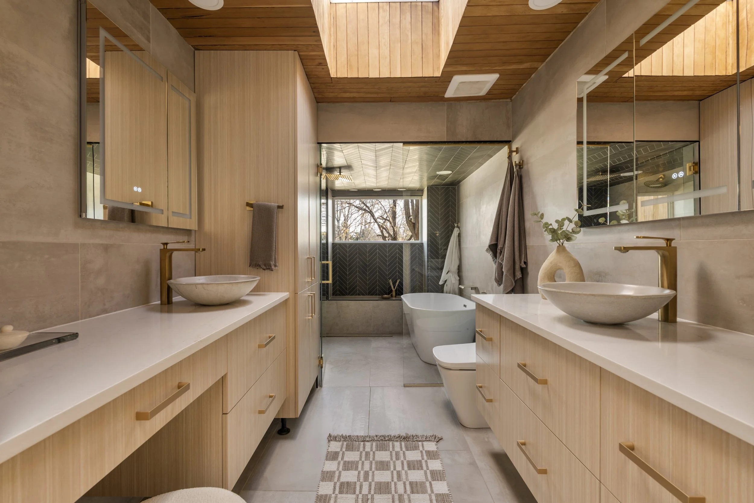 Modern Denver bathroom with double vanity, wood cabinetry, and contemporary finishes
