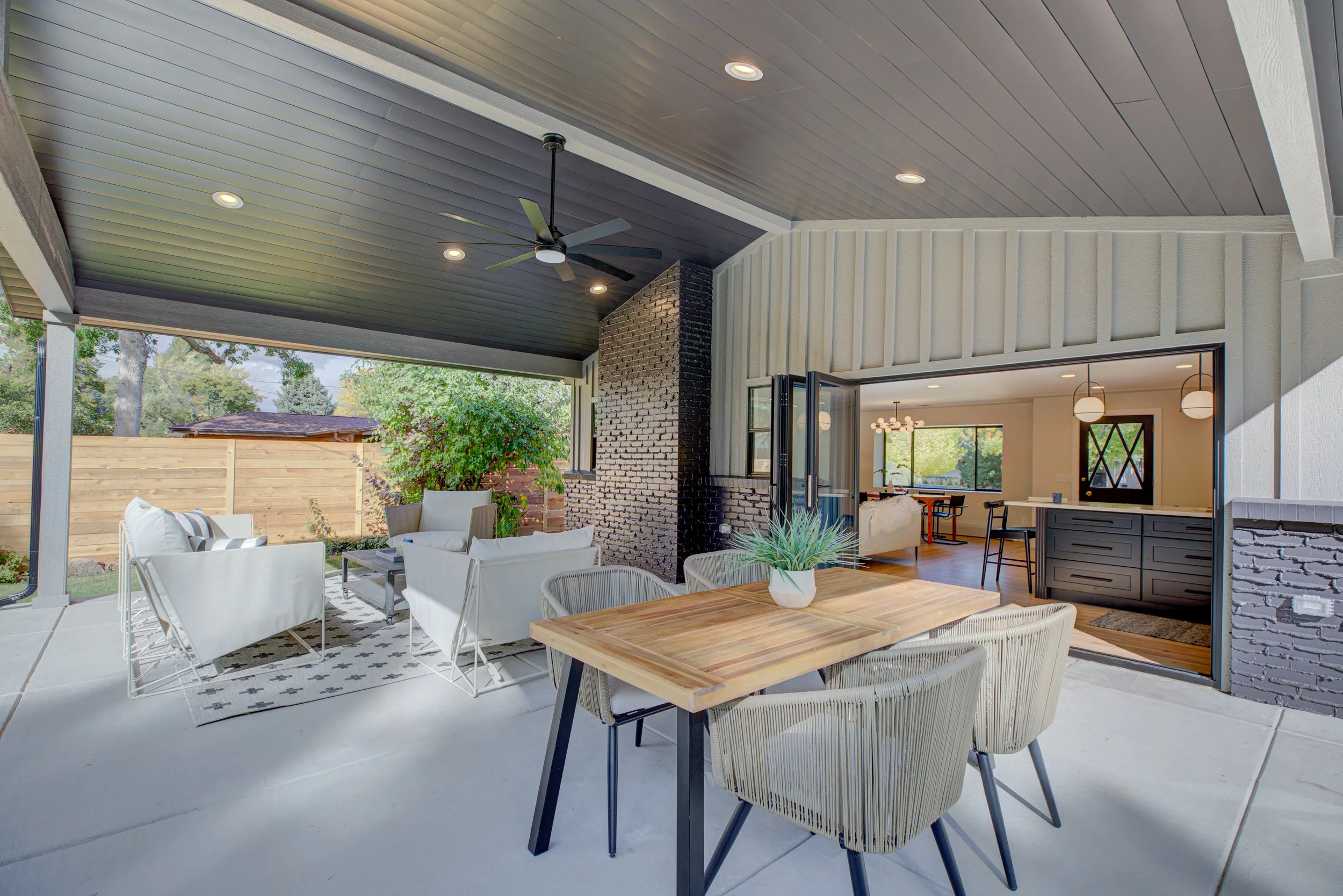 Covered outdoor patio and indoor-outdoor living space staged for selling a home in Denver.