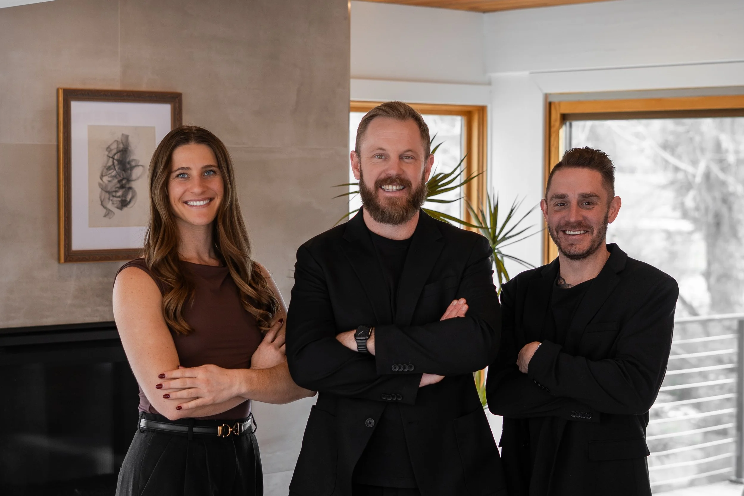 The Eminence Group Denver real estate team standing together in a modern Denver home.