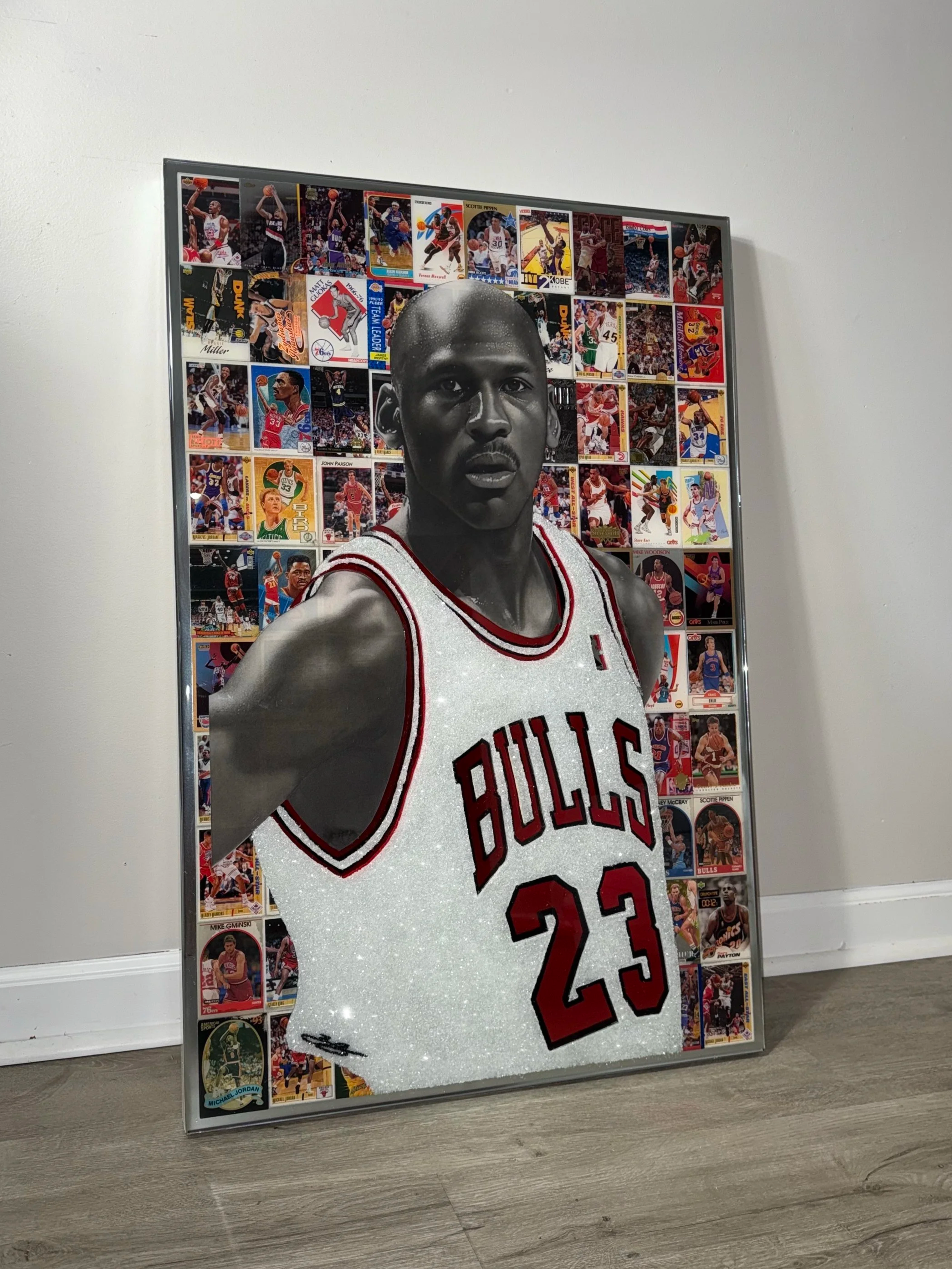 Graphite portrait layered over original NBA trading cards from Michael Jordan's active years. Stained glass paint, ink, resin and diamond dust on mirror. Mounted to canvas. 24 x 36 in.