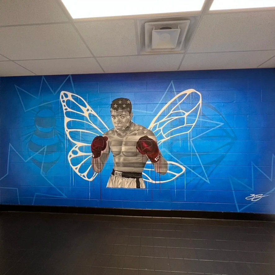 Interior mural commissioned by the LeBron James Family Foundation for House Three Thirty. The portrait of Muhammad Ali was created using acrylic and oil paint, honoring legacy, resilience and cultural impact.