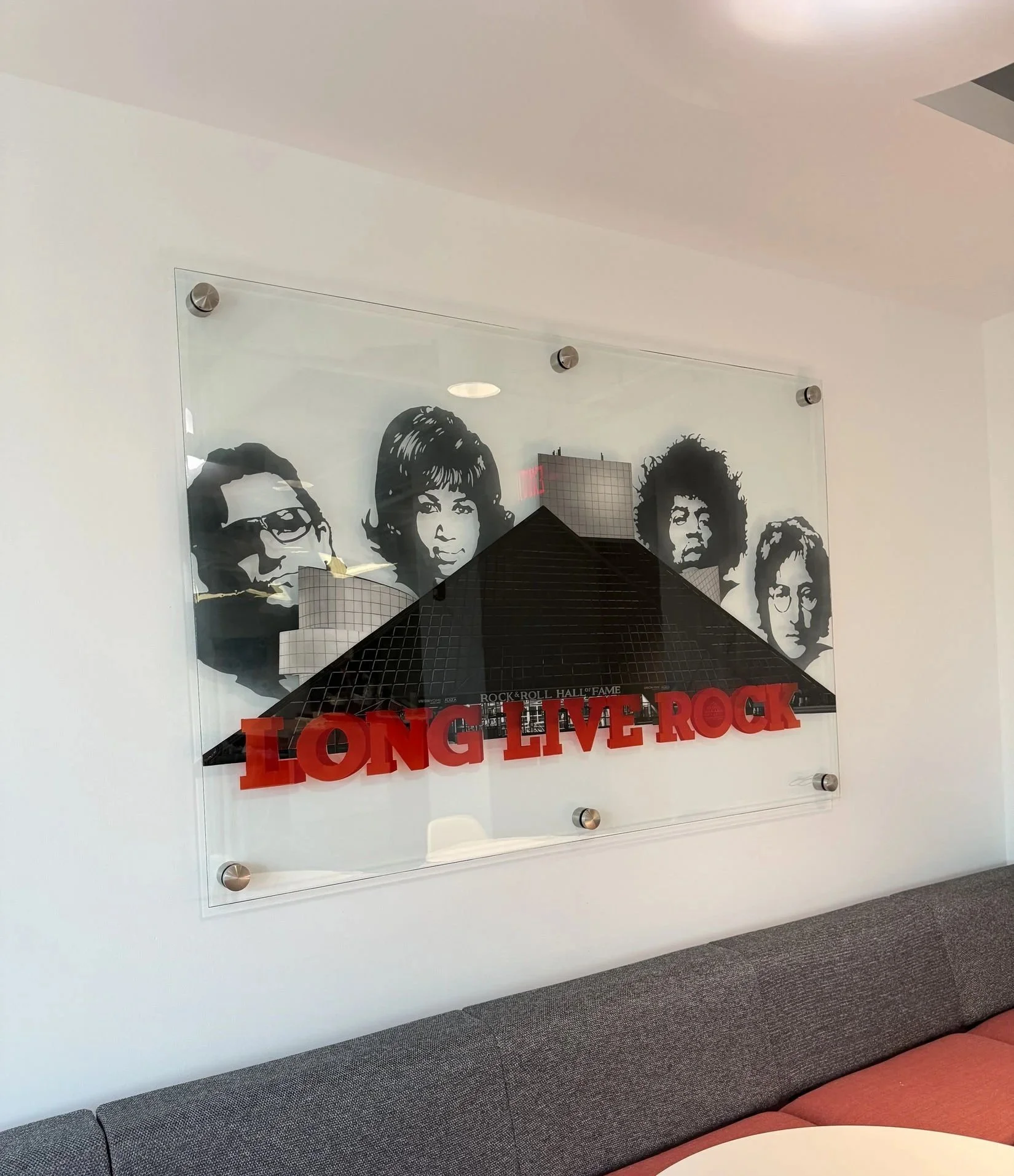 Rock & Roll Hall of Fame inspired installation featuring hand-painted building elements & layered stained glass on 4ft x 6ft tempered glass. Finished with epoxy resin & mounted using standoff mounting. 
