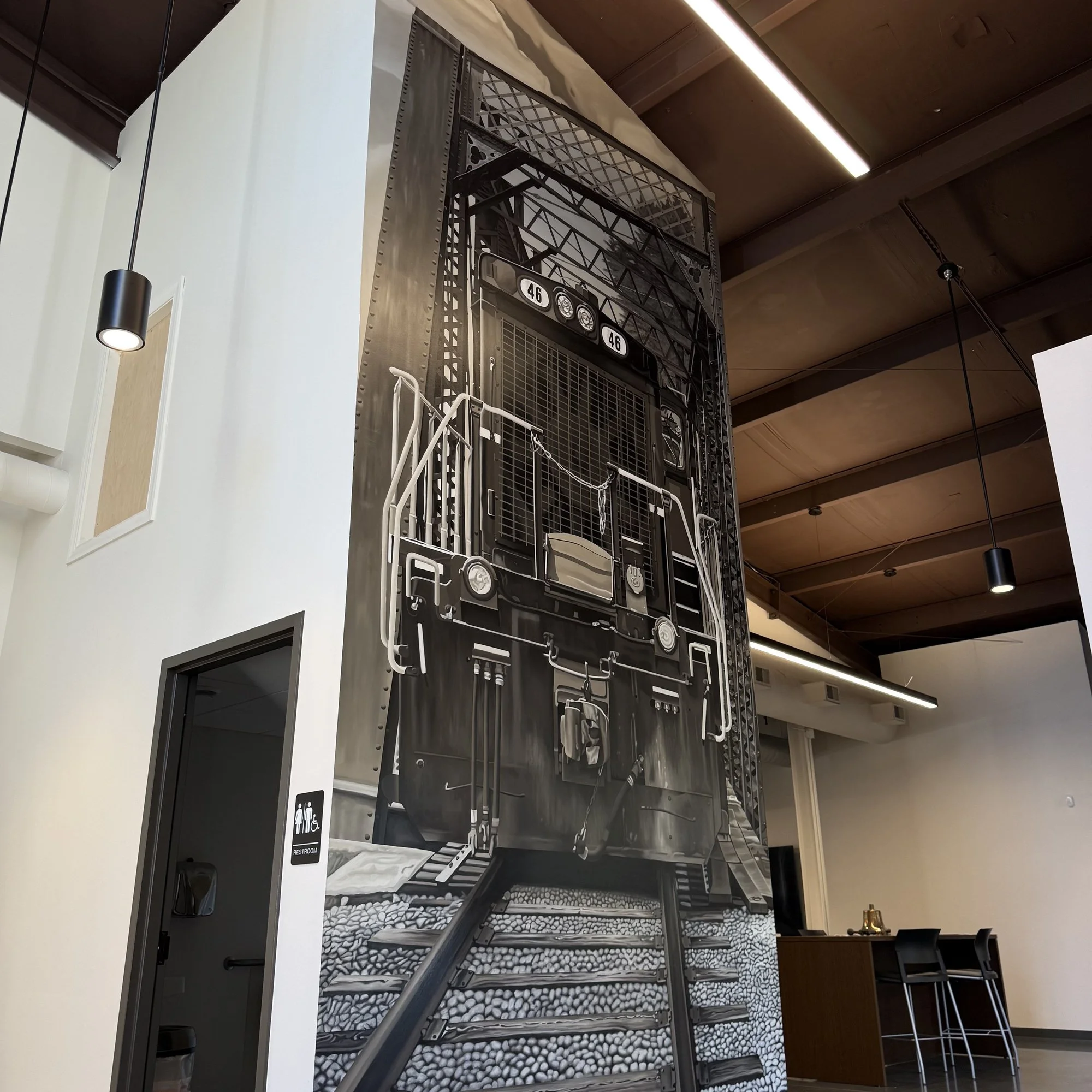 This 19' x 9' hyperrealistic mural was hand-painted in acrylic for New Castle Industrial Railroad, accompanied by the historic logos of its connecting railroads to honor the region's rich railroad heritage.