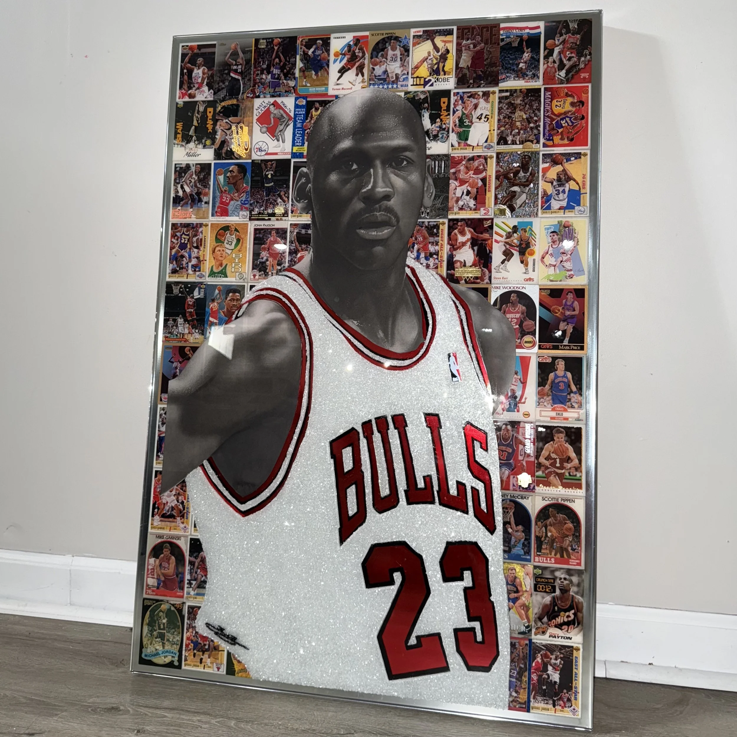 Graphite portrait layered over original NBA trading cards from Michael Jordan's active years. Stained glass paint, ink, resin and diamond dust on mirror. Mounted to canvas. 24 x 36 in.