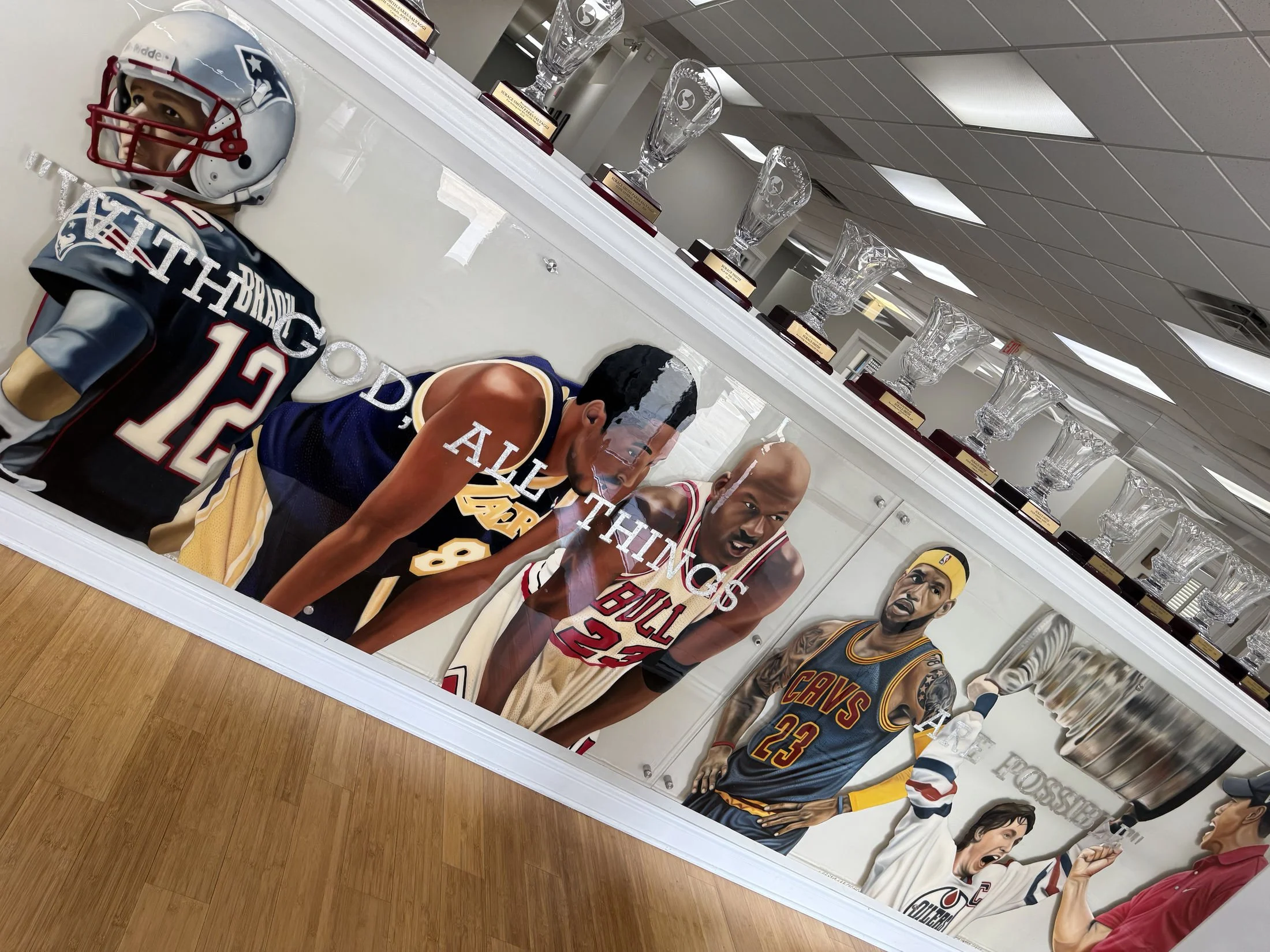 Mixed-media sports installation featuring oil paintings on unstretched canvas, layered on plexiglass. Finished in epoxy resin and mounted with stainless-steel standoff hardware. Two-panel installation measuring 4ft x 20ft overall. 