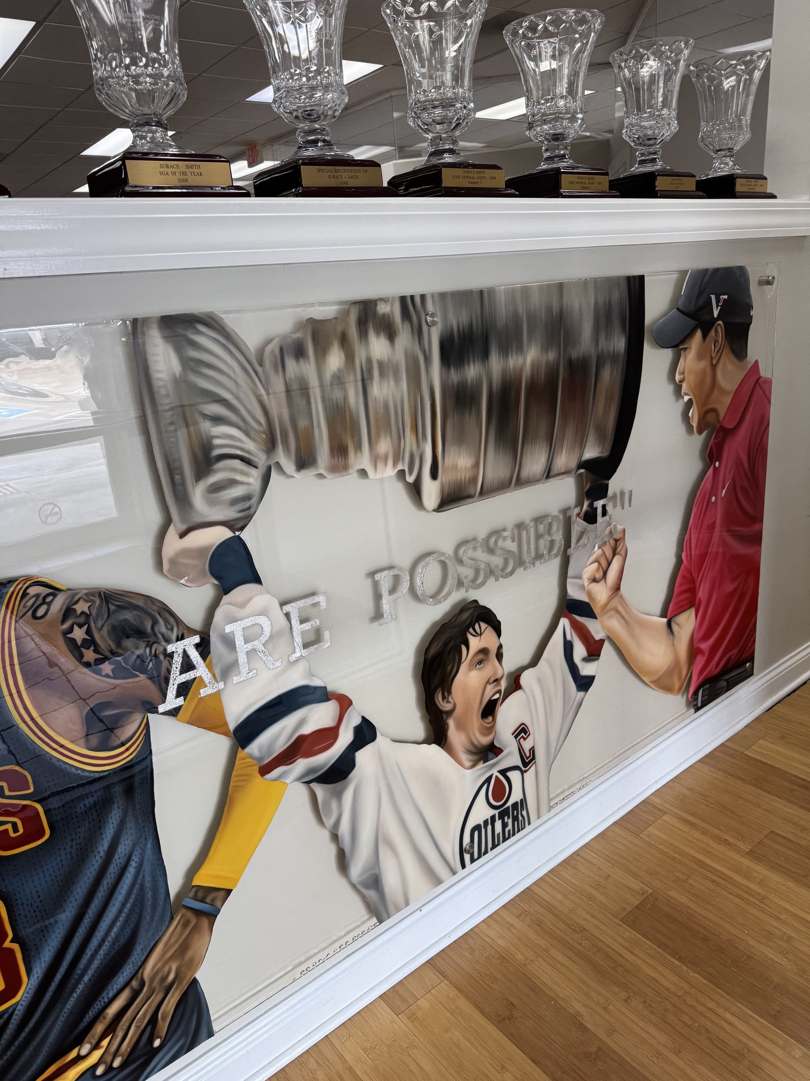 Mixed-media sports installation featuring oil paintings on unstretched canvas, layered on plexiglass. Finished in epoxy resin and mounted with stainless-steel standoff hardware. Two-panel installation measuring 4ft x 20ft overall. 