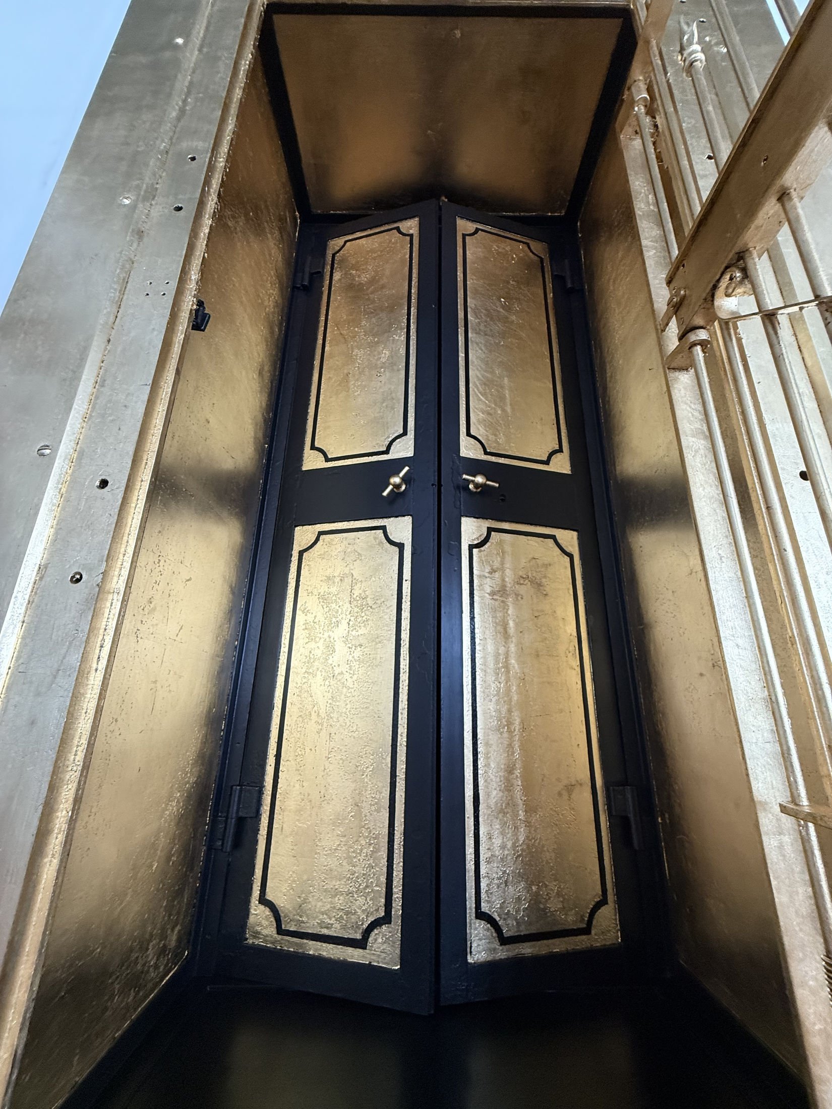Restoration and redesign of historic bank vaults built in 1818 within the oldest commercial building in Canton, Ohio. Featuring hand-applied gold leaf, custom detailing, and architectural enamel finishes throughout the installation.