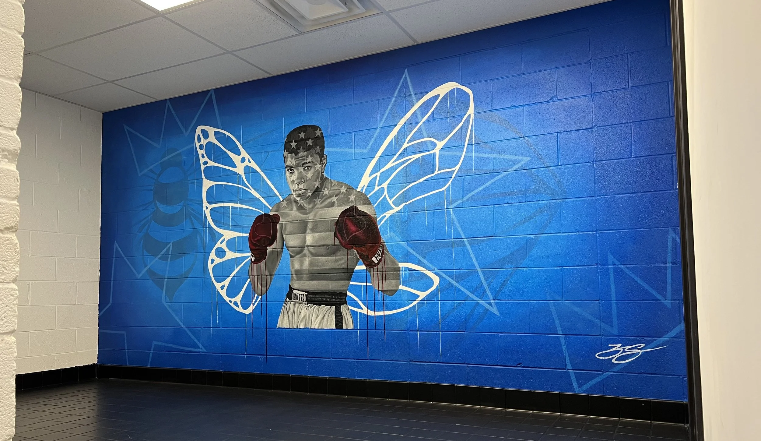 Interior mural commissioned by the LeBron James Family Foundation for House Three Thirty. The portrait of Muhammad Ali was created using acrylic and oil paint, honoring legacy, resilience and cultural impact.