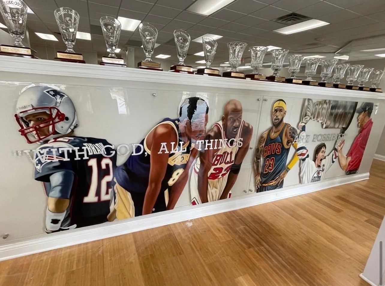 Mixed-media sports installation featuring oil paintings on unstretched canvas, layered on plexiglass. Finished in epoxy resin and mounted with stainless-steel standoff hardware. Two-panel installation measuring 4ft x 20ft overall. 