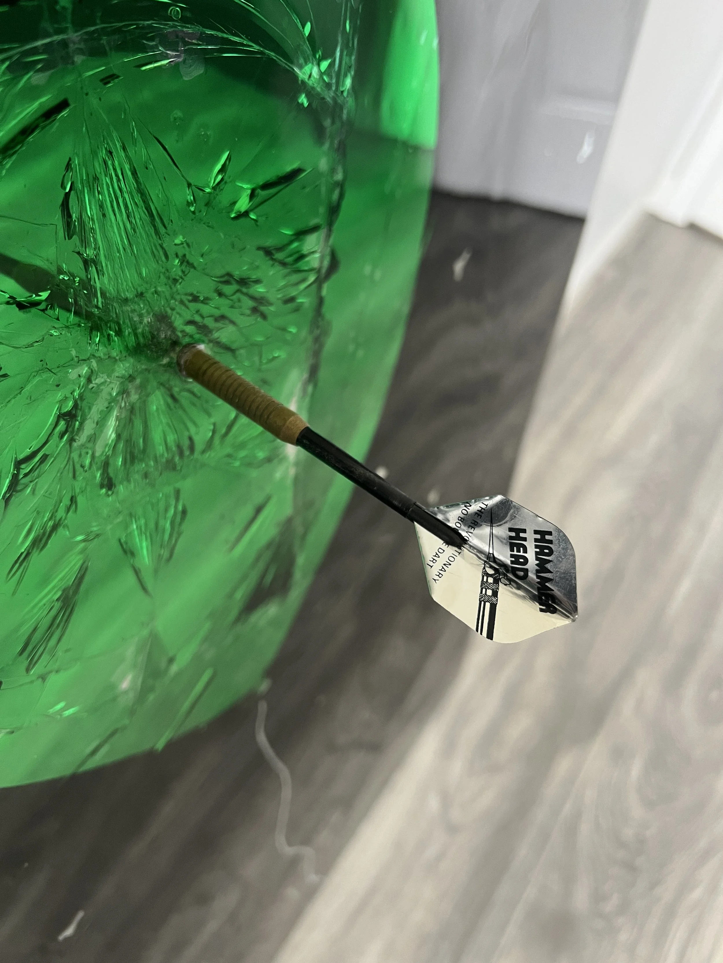 Stained glass paint, spray paint, acrylic, epoxy resin and a real playing dart on intentionally-shattered mirror. Mounted to canvas. 24 x 36 in.