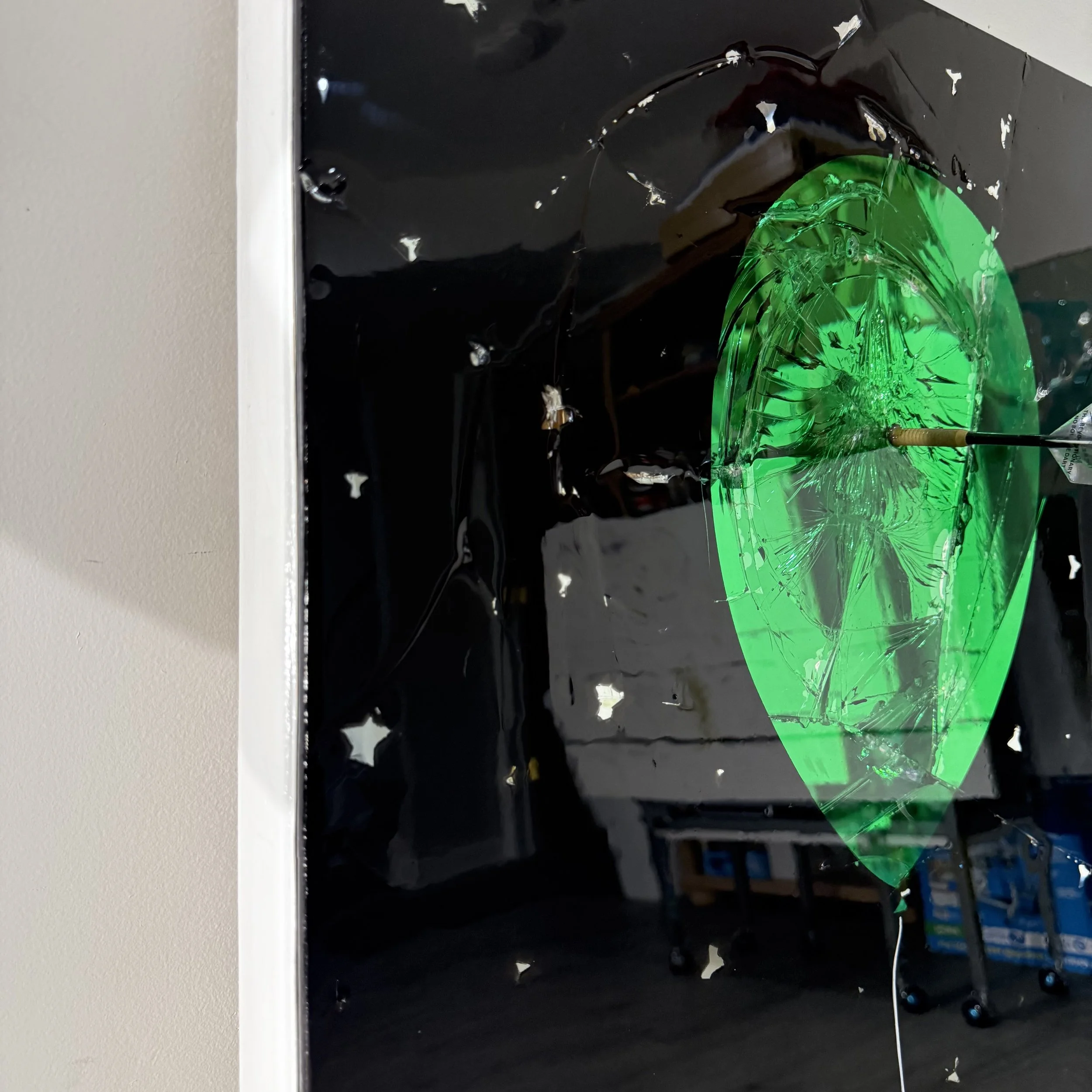 Stained glass paint, spray paint, acrylic, epoxy resin and a real playing dart on intentionally-shattered mirror. Mounted to canvas. 24 x 36 in.