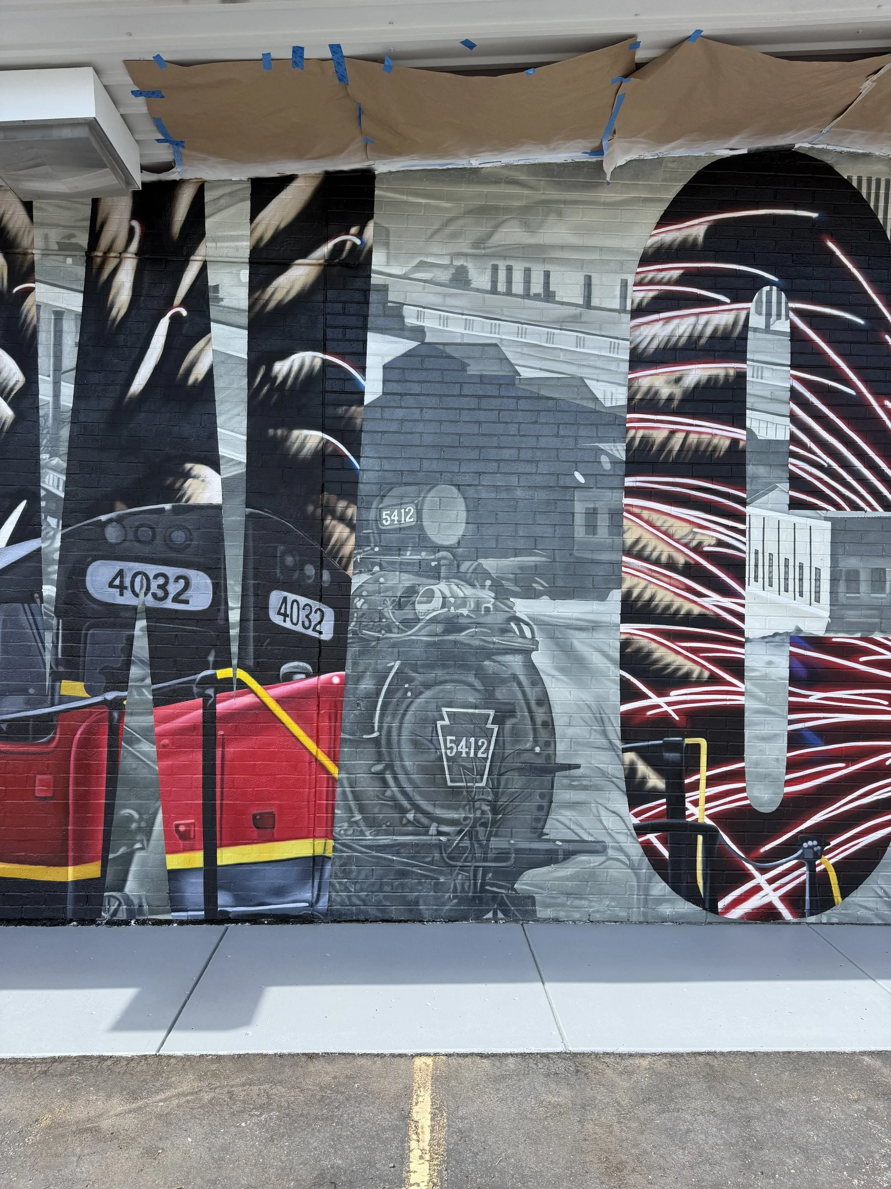 This large-scale mural was designed to captured the identity of New Castle by contrasting its industrial heritage with the city's modern character. Hand-painted across a 50' x 18' wall using acrylic, oil, and spray paint.