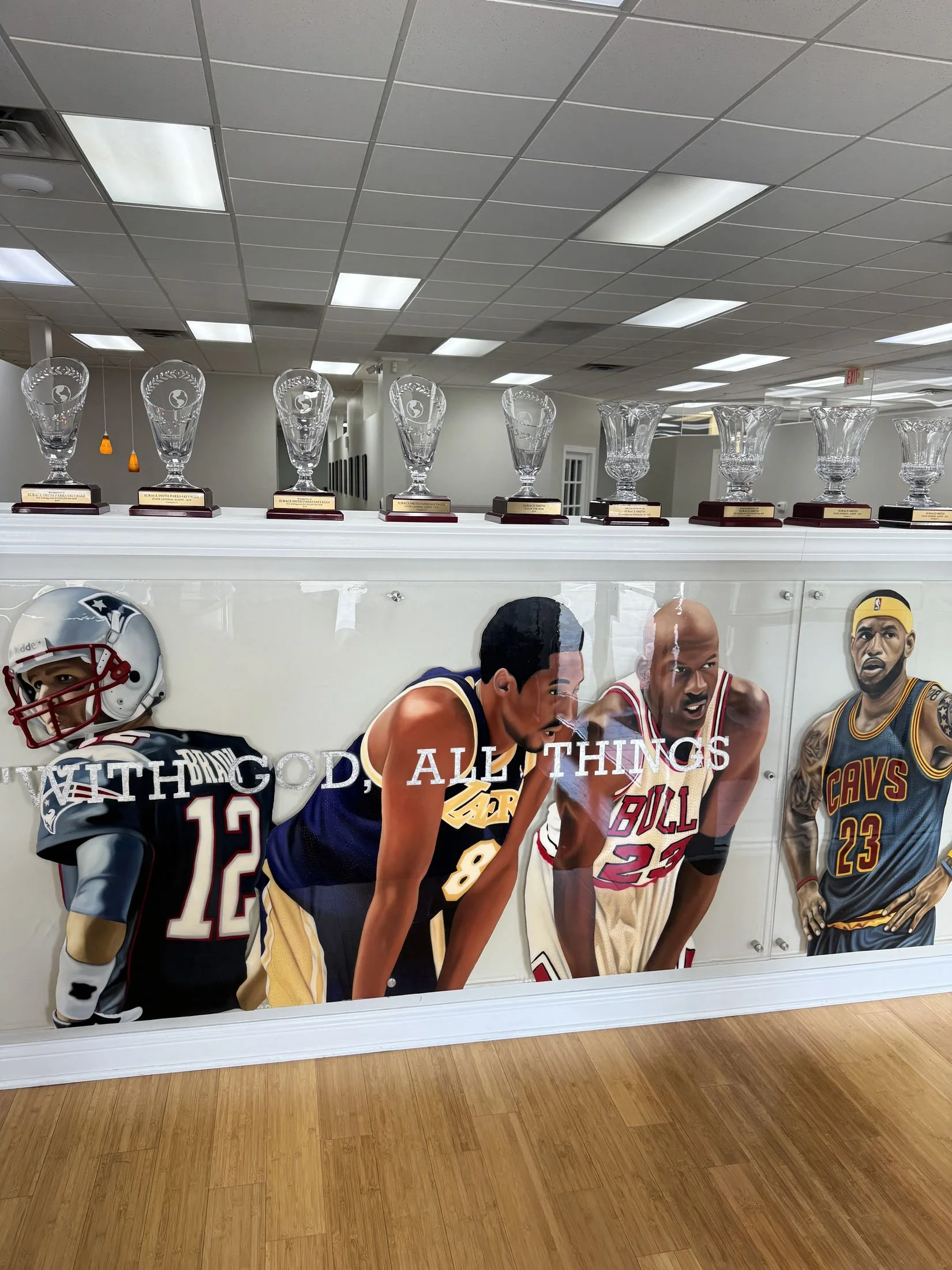 Mixed-media sports installation featuring oil paintings on unstretched canvas, layered on plexiglass. Finished in epoxy resin and mounted with stainless-steel standoff hardware. Two-panel installation measuring 4ft x 20ft overall. 