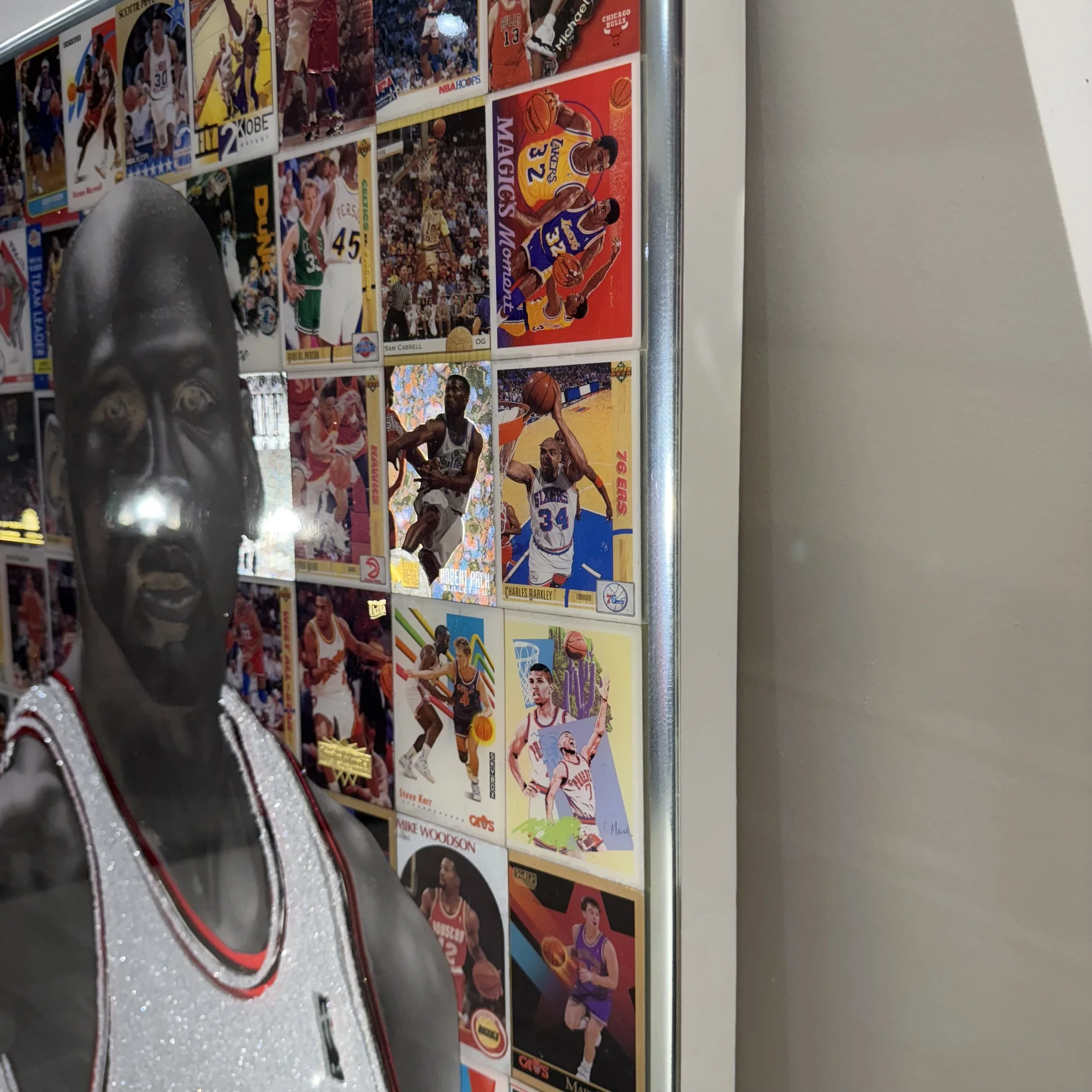 Graphite portrait layered over original NBA trading cards from Michael Jordan's active years. Stained glass paint, ink, resin and diamond dust on mirror. Mounted to canvas. 24 x 36 in.