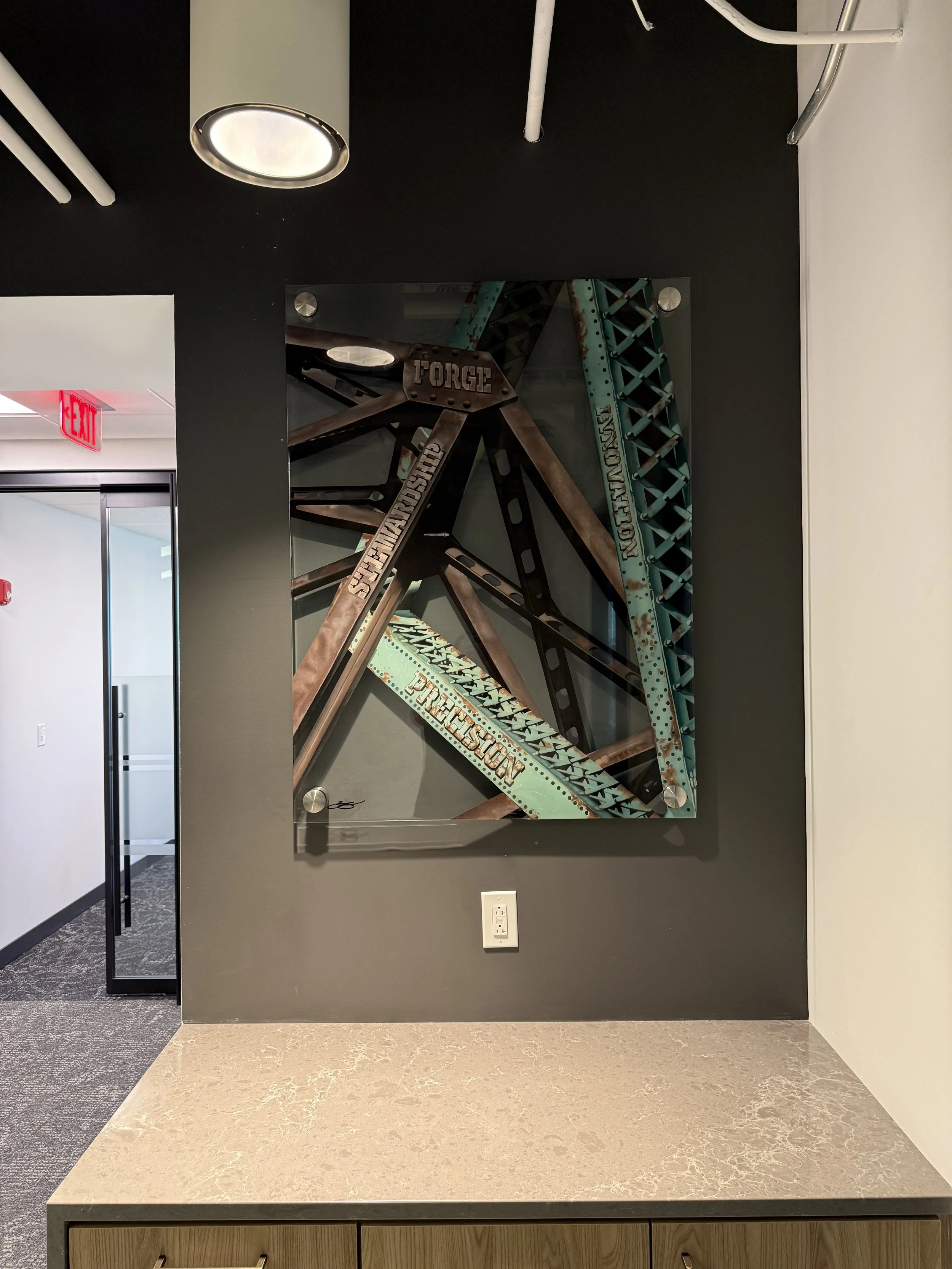 Cleveland steel industry inspired glass installation featuring industrial bridge structures painted on 3ft x 4ft tempered glass. Finished with epoxy resin and floating stainless steel standoff mounting. Approximately 150 hours in creation.