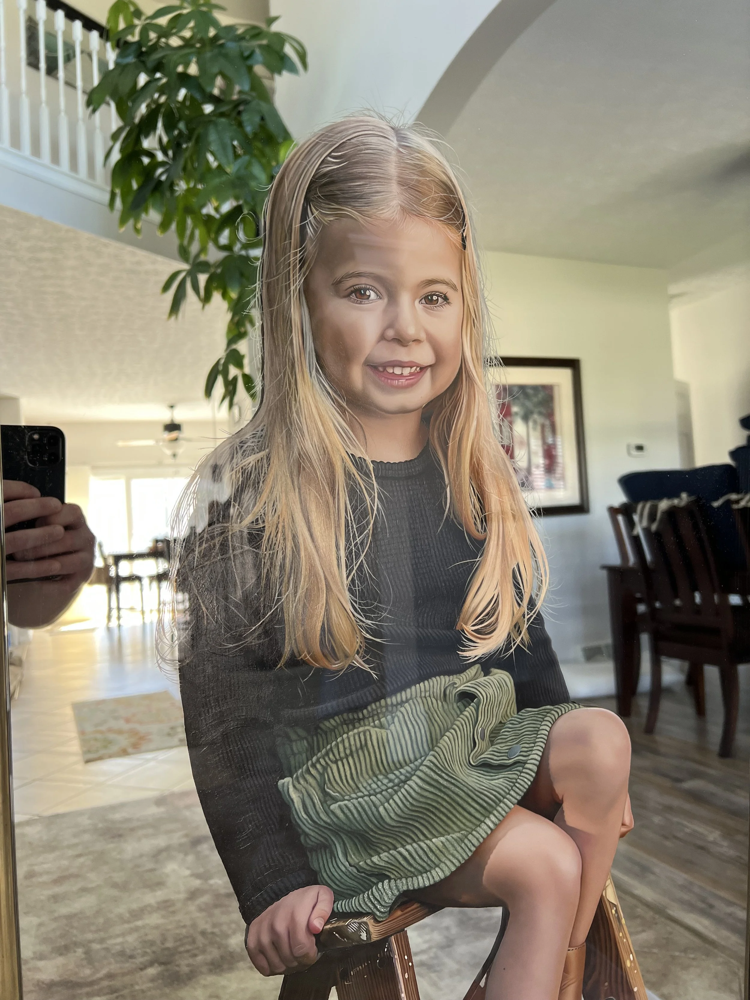 Realism portrait painted with oil paint on a 22" x 56" mirror. Created for a private client, the work merges hyper-detailed realism with a reflective mirror surface and a custom frame. 