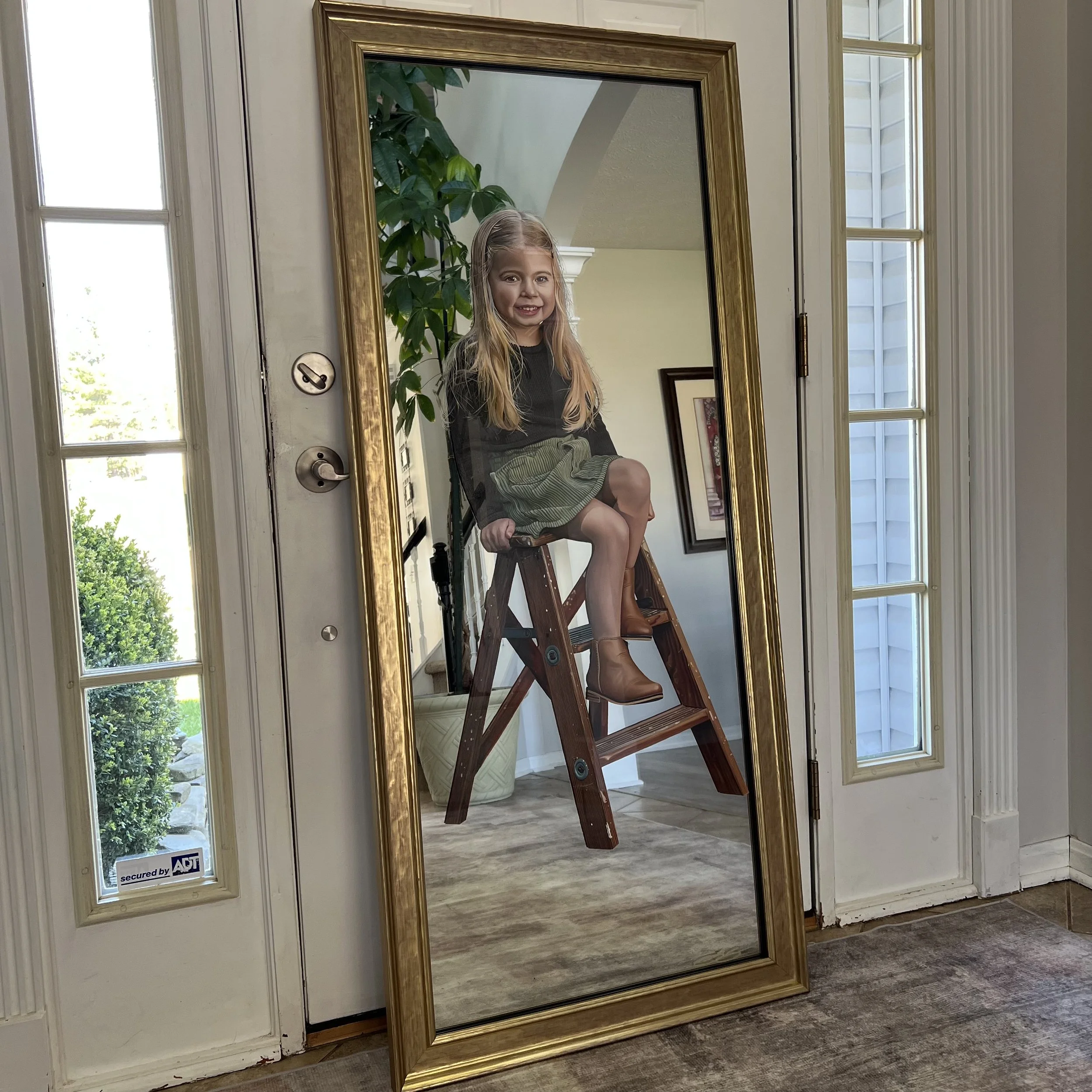 Realism portrait painted with oil paint on a 22" x 56" mirror. Created for a private client, the work merges hyper-detailed realism with a reflective mirror surface and a custom frame. 