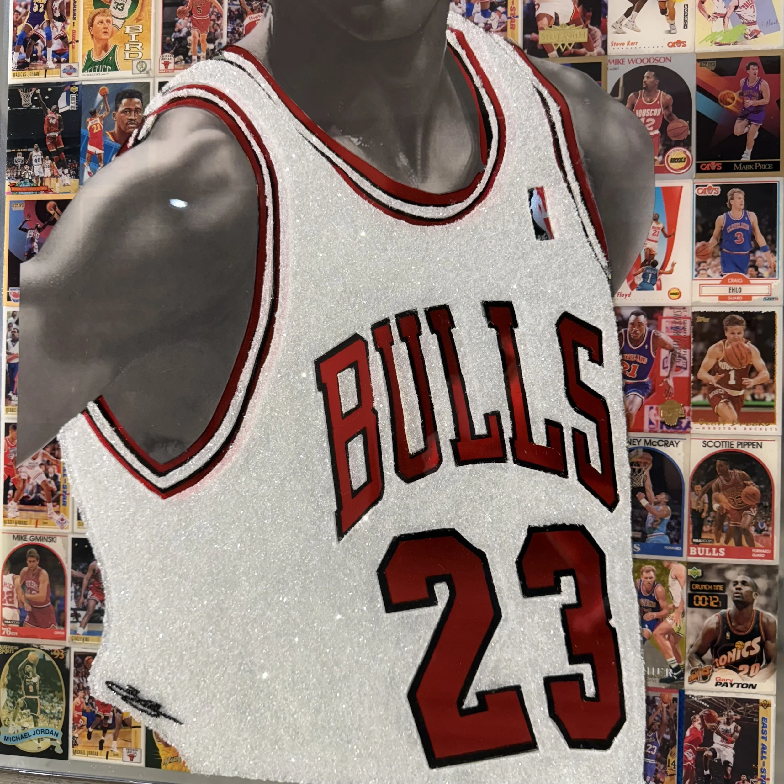 Graphite portrait layered over original NBA trading cards from Michael Jordan's active years. Stained glass paint, ink, resin and diamond dust on mirror. Mounted to canvas. 24 x 36 in.