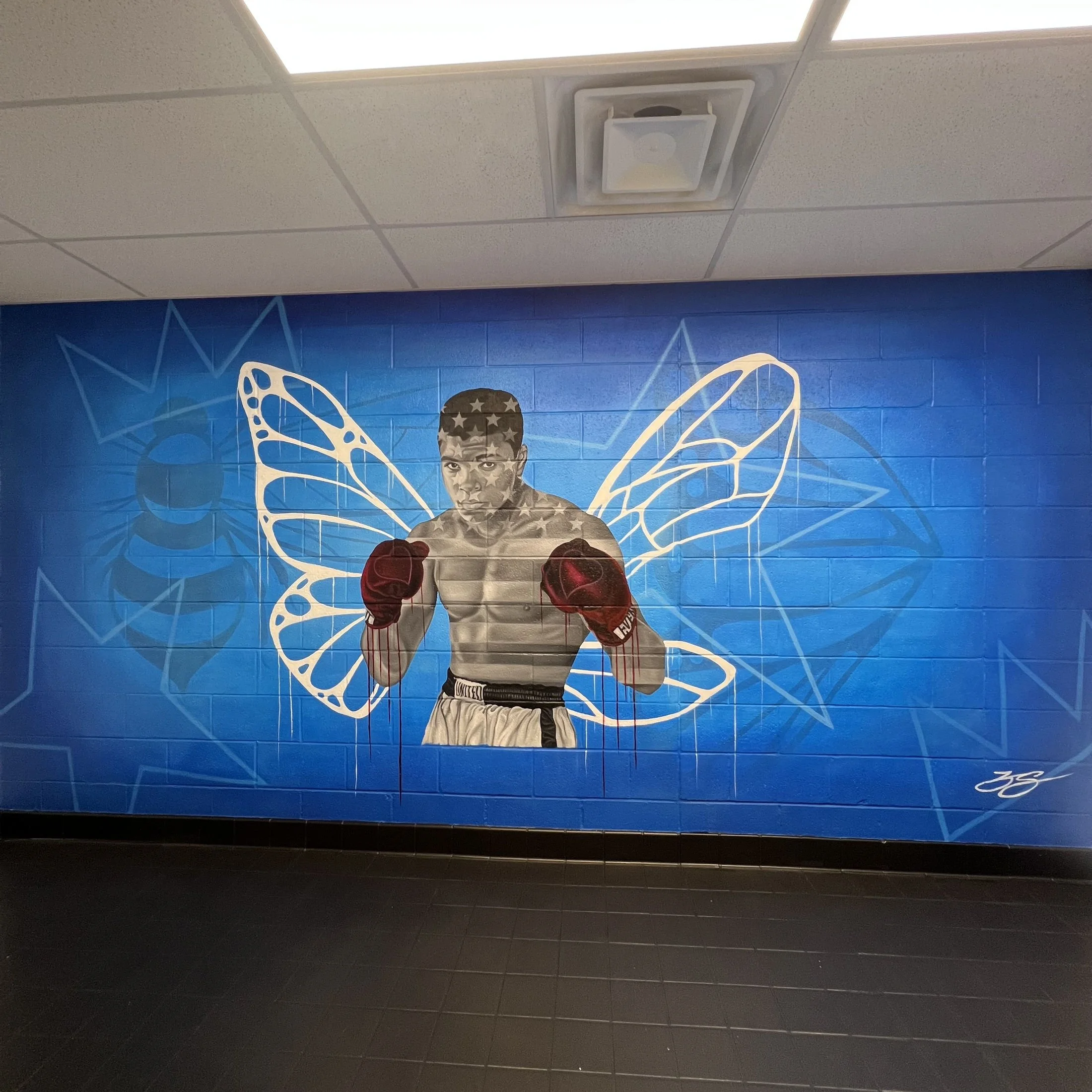 Interior mural commissioned by the LeBron James Family Foundation for House Three Thirty. The portrait of Muhammad Ali was created using acrylic and oil paint, honoring legacy, resilience and cultural impact.