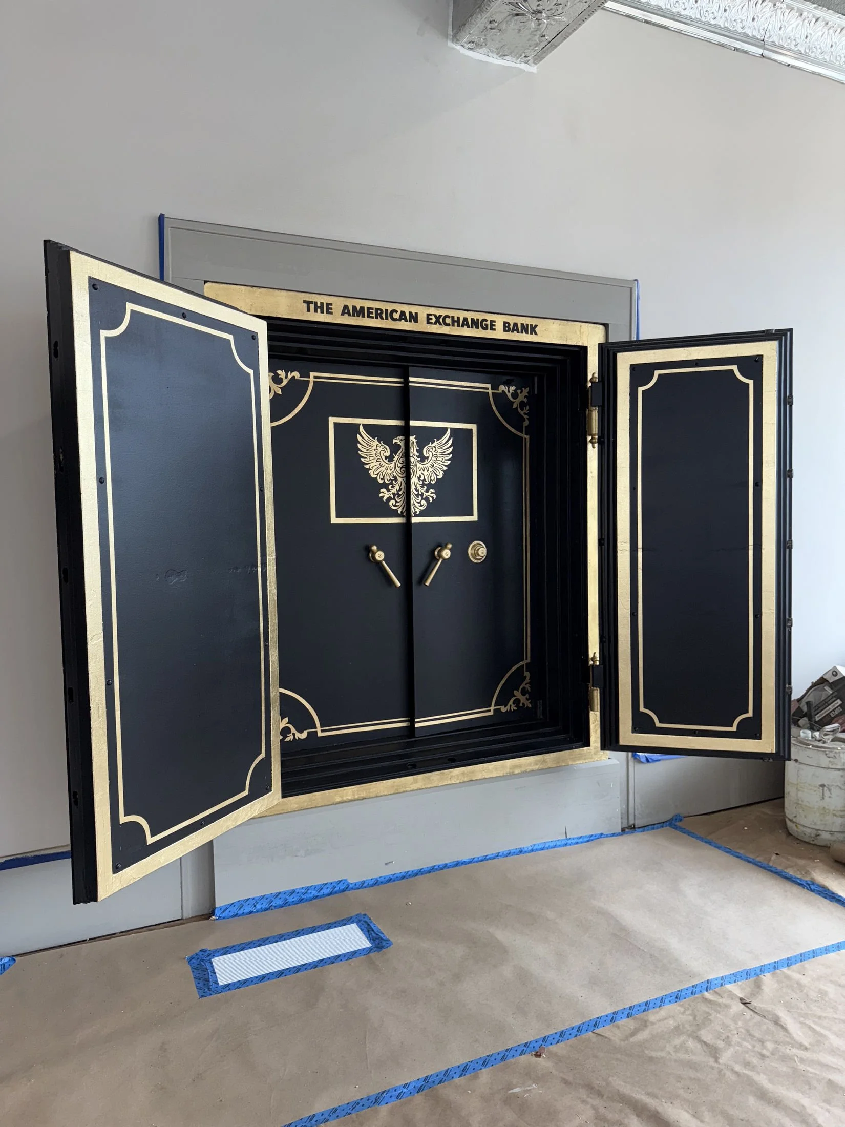 Restoration and redesign of historic bank vaults built in 1818 within the oldest commercial building in Canton, Ohio. Featuring hand-applied gold leaf, custom detailing, and architectural enamel finishes throughout the installation.