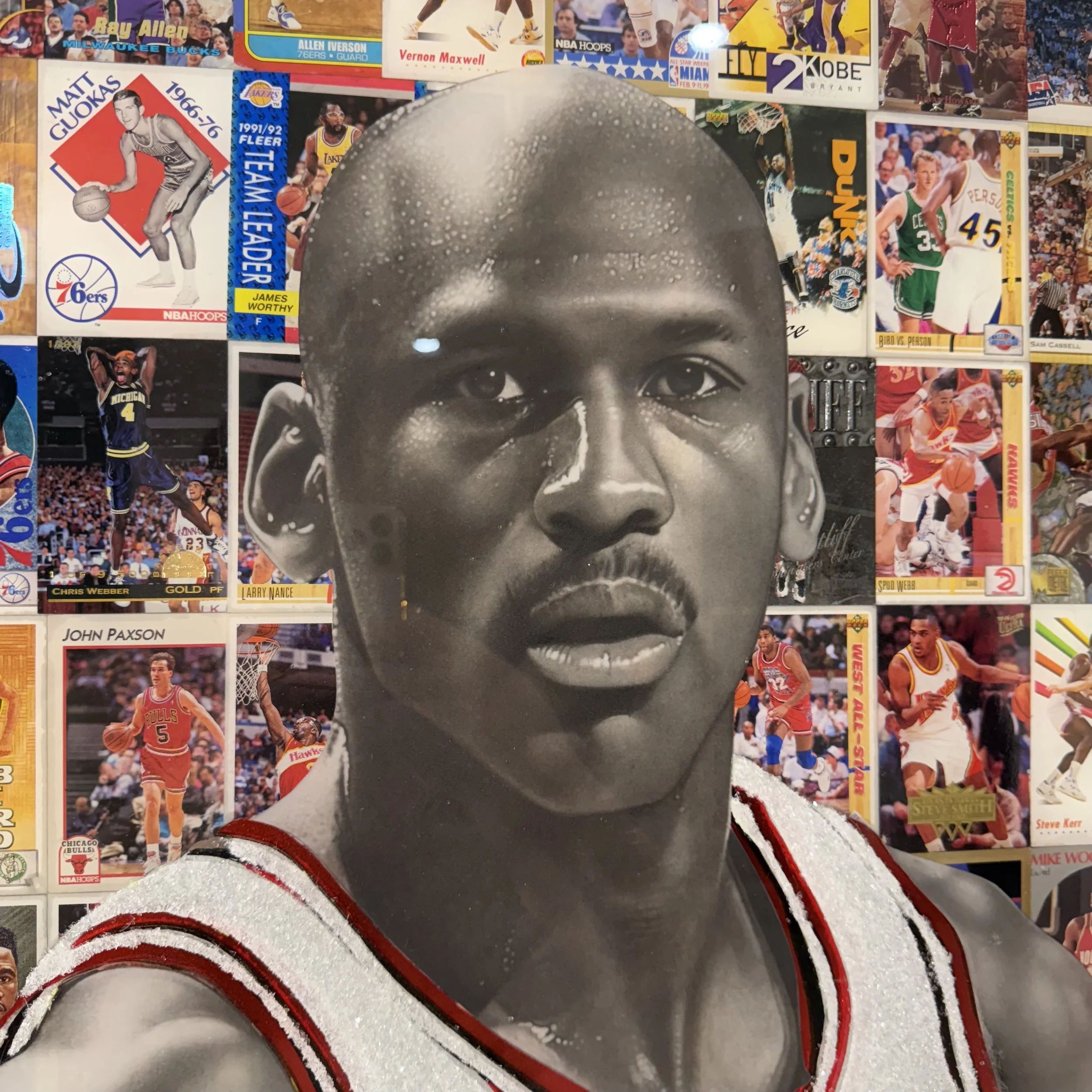 Graphite portrait layered over original NBA trading cards from Michael Jordan's active years. Stained glass paint, ink, resin and diamond dust on mirror. Mounted to canvas. 24 x 36 in.