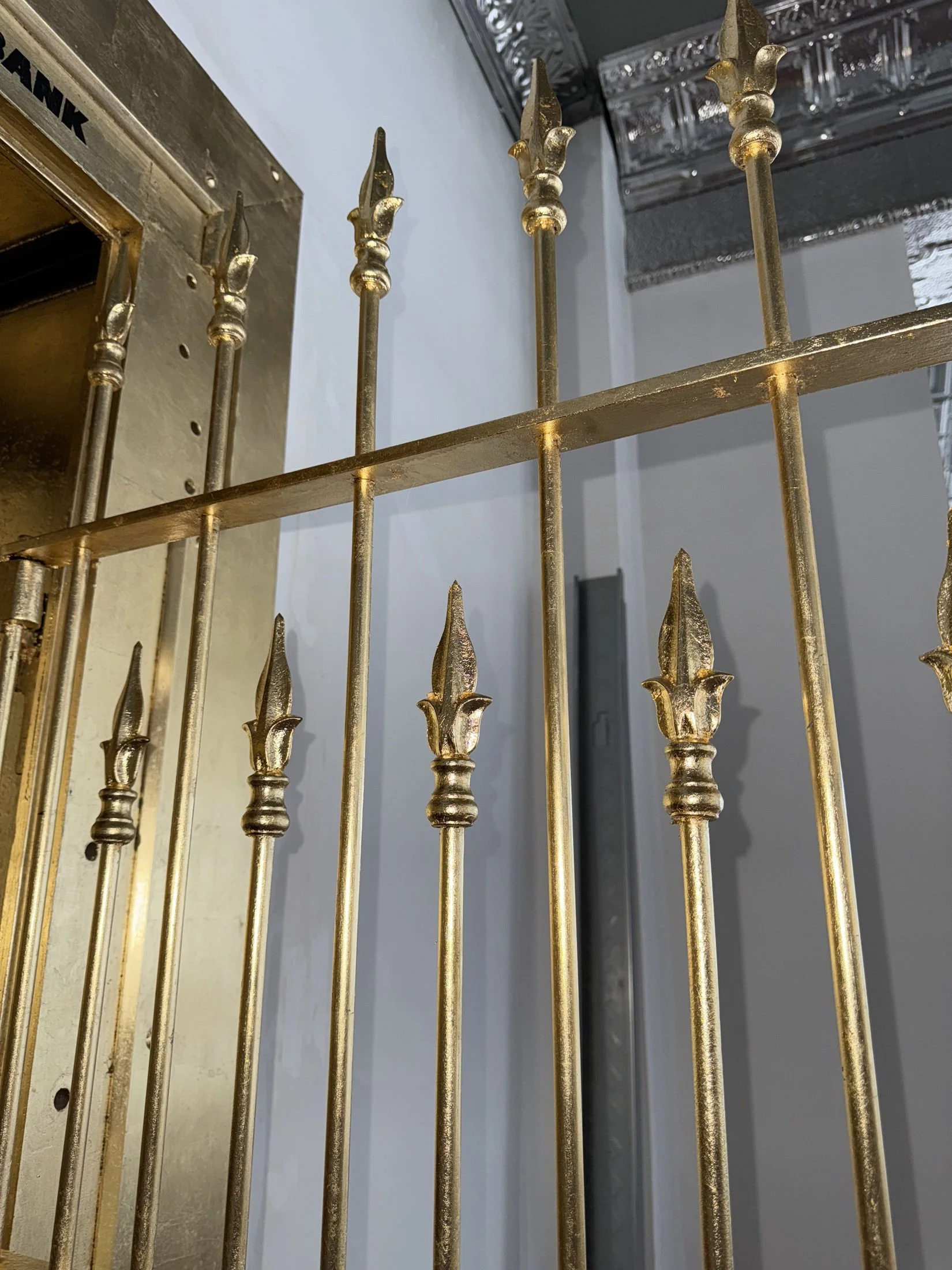 Restoration and redesign of historic bank vaults built in 1818 within the oldest commercial building in Canton, Ohio. Featuring hand-applied gold leaf, custom detailing, and architectural enamel finishes throughout the installation.
