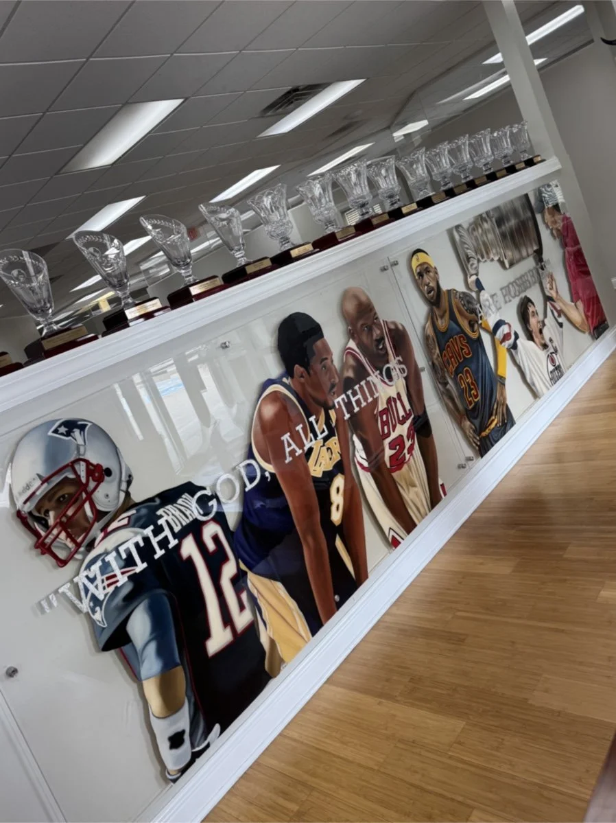 Mixed-media sports installation featuring oil paintings on unstretched canvas, layered on plexiglass. Finished in epoxy resin and mounted with stainless-steel standoff hardware. Two-panel installation measuring 4ft x 20ft overall. 