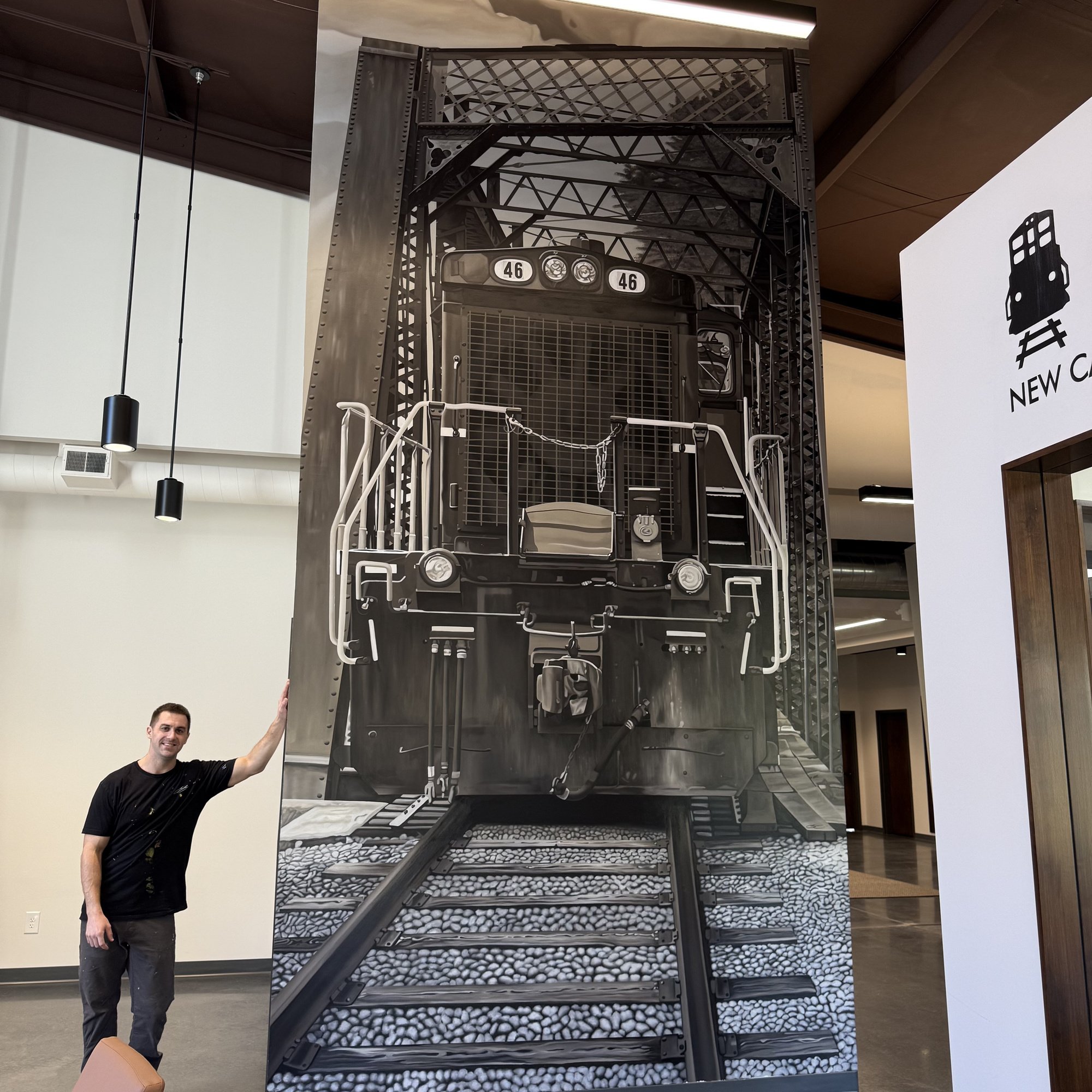 This 19' x 9' hyperrealistic mural was hand-painted in acrylic for New Castle Industrial Railroad, accompanied by the historic logos of its connecting railroads to honor the region's rich railroad heritage.