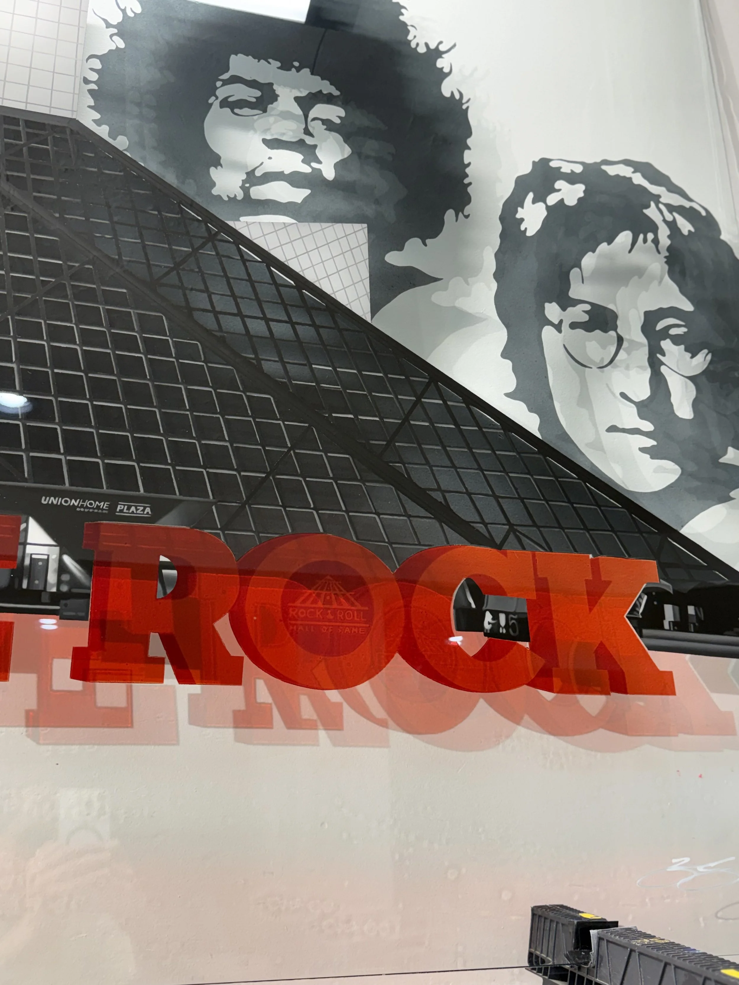 Rock & Roll Hall of Fame inspired glass installation created with oil paint, layered stained glass techniques and epoxy resin on 4ft x 6ft tempered glass. Installed using floating stainless steel standoffs. Over 200 hours in creation.