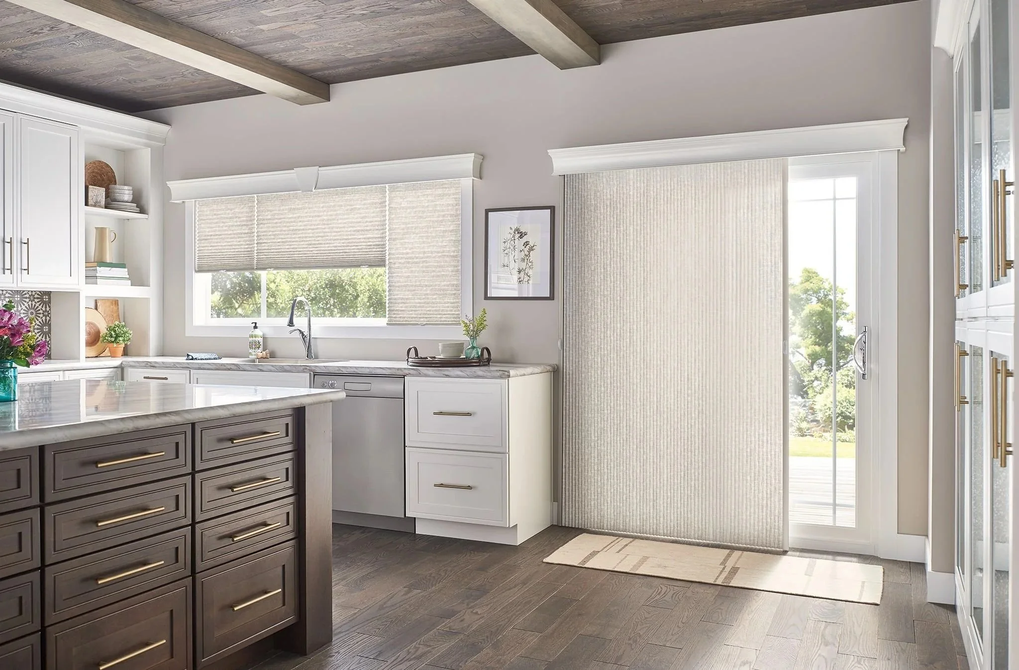 Modern kitchen with white cabinetry, a gray island, hardwood floors, and a sliding glass door with vertical blinds leading outside.