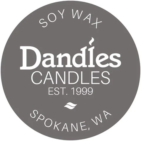 Gray circular logo for Dandles Candles, a soy wax candle company in Spokane, Washington, established in 1999, with company name and location text.
